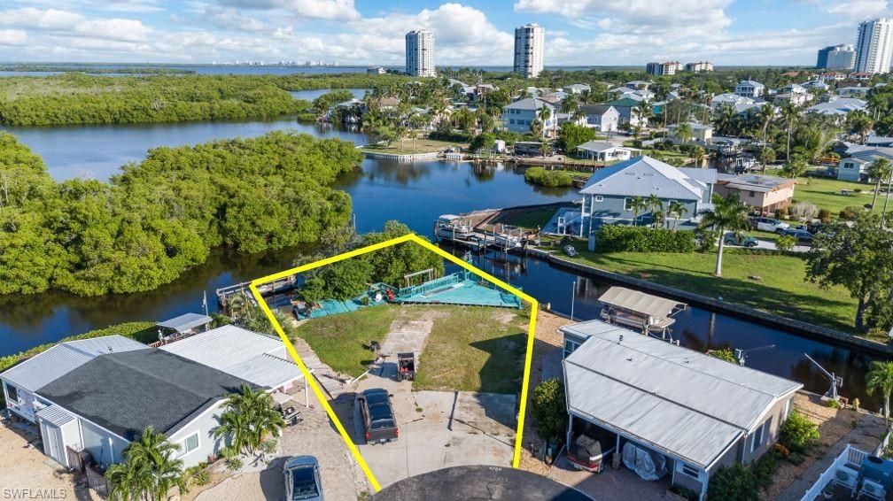 DIRECT GULF ACCESS CUL-DE-SAC LOT WITH STUNNING BAY VIEWS IN SPRING CREEK VILLAGE! Tucked at the end of a quiet cul-de-sac, this prime 0.22-acre waterfront lot (9,670 sq ft) offers panoramic bay and navigable creek vistas with desirable Northwest rear exposure—the ultimate setting for watching famous Southwest Florida sunsets over the water! Boaters will love the existing private dock complete with a boat lift and canopy cover, providing instant, hassle-free water access. Enjoy a scenic 5–10 minute cruise out to Estero Bay or ~15 minutes to New Pass, Lovers Key, and the open waters of the Gulf of Mexico. Manatees and dolphins are daily visitors right off your backyard! Central water, sewer, electric, and cable are all available at the site. Located in Spring Creek Village, a resident-owned 55+ boating community with remarkably low HOA fees ($290/yr). Enjoy resort-style amenities including a clubhouse, heated pool & spa, tennis, pickleball, boat ramp, kayak launch, and fishing lake. Minutes to Coconut Point Mall, dining, and RSW Airport!