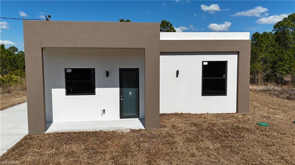 This one-of-a-kind property presents an excellent opportunity for first-time homebuyers, investors, or anyone seeking a secure, durable, and modern home with distinctive architectural appeal
Modern design meets exceptional durability in this unique 2-bedroom, 2-bath residence located in Lehigh Acres, with a peaceful canal directly behind the property providing added privacy and a tranquil setting. Constructed with innovative 100% concrete walls and a durable flat roof, this bunker-style home offers outstanding strength, energy efficiency, and long-term resilience.
The interior features impact-resistant windows that allow abundant natural light while enhancing security and storm protection. Contemporary finishes throughout include quartz countertops, and a low-maintenance design that complements today's lifestyle. The open and functional floor plan provides comfortable living spaces ideal for homeowners or investors alike.
Enjoy the scenic canal views from your backyard and the peace of mind that comes with a uniquely built concrete home designed to withstand Florida's climate.
secure, durable, and modern home with distinctive architectural appeal.

Property is being sold AS-IS. Buyer is encouraged to conduct all desired inspections and due diligence. The air conditioning system is currently operational but requires Freon/refrigerant service. The water treatment system is not included in the sale and will not convey with the property. Seller will make no repairs or replacements. Some pictures are virtually staged.