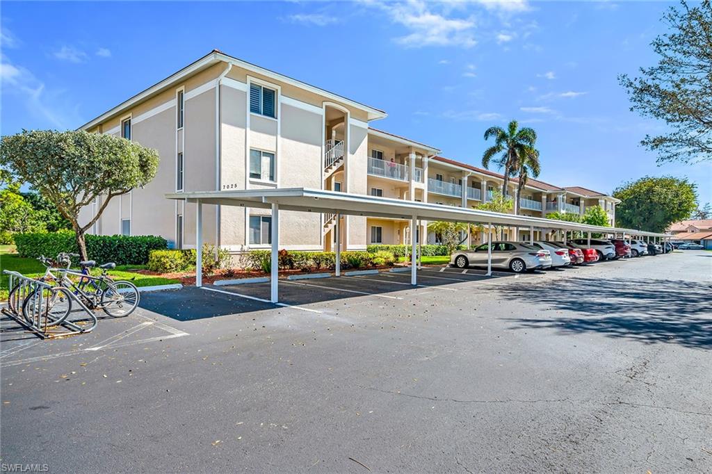 Positioned within Chatham Square at Glen Eagle, this inviting residence offers a sought-after bundled golf membership along with tranquil lake and golf course views. Enjoy tranquil views from your private screened lanai overlooking the lush fairways and sparkling lake, creating a peaceful backdrop for everyday living and relaxed outdoor enjoyment. With a desirable second-floor vantage point and a dedicated carport space, this two-bedroom, two-bath condominium presents an exceptional opportunity to embrace Naples golf lifestyle. The thoughtfully designed floor plan features a bright and open living and dining area with direct lanai access, allowing the beautiful lake and golf course views to become part of your daily experience. A formal dining space flows seamlessly into the living room, making the layout ideal for relaxed evenings and entertaining guests. The screened lanai, complete with a ceiling fan, provides comfortable outdoor living year-round while capturing sweeping views of the course and water. The kitchen is functional and inviting, offering a convenient pass-through window to the living room, a pantry for added storage, and a charming breakfast area set by a window with a ceiling fan. Appliances include a range, microwave and refrigerator/freezer, providing everything needed for effortless meal preparation. The primary suite serves as a comfortable retreat, featuring a ceiling fan and golf course views. The en-suite bath includes a sink vanity with a framed mirror and a shower-tub combination. The guest bedroom is thoughtfully positioned adjacent to a full bath with a shower-tub combo and includes ceiling fans for added comfort, making it ideal for visitors or flexible use as a home office. Residents of Glen Eagle Golf & Country Club enjoy an active, amenity-rich lifestyle centered around the 18-hole championship course. Additional offerings include tennis courts, a fitness center, resort-style pool, clubhouse dining and a vibrant year-round social calendar. Ideally in South Naples, this community is just minutes from the white sand beaches of the Gulf and renowned destinations of Old Naples, Fifth Avenue South, Third Street South, Naples Pier, Waterside Shops, Artis—Naples, Venetian Bay, Bayfront and Mercato, offering the best of Naples living.