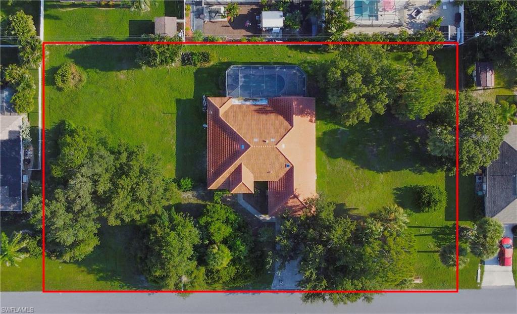 Rare find in Port Charlotte! This spacious 3-bed, 2-bath home offers 2,071 sq. ft. of living space and sits on an incredible .69-acre compound comprised of three combined lots, no flood zone, and on city water and sewer. Enjoy ultimate privacy, park an RV, build a guest house, or utilize the extra lots as a future investment asset. The home features vaulted ceilings, a formal living/dining room, a family room, and a generous master suite with an office nook. The master bath has dual-sinks, separate soaking tub and walk-in shower. Shared areas are ceramic tile and wood-laminate flooring. Major updates include a new tile roof (2023) and a brand-new AC (July 2026). Step outside to a screened lanai with a large under-truss area, pavers, and an in-ground heated pool with a spa and jet-stream swim system. Flexible Customization Credits: Rather than locking a buyer into someone else's aesthetic choices, the sellers are offering closing credits to make the home truly yours. $10000 to replace the carpet. $12000 to re-paint. $5000 for kitchen appliance package.  Includes washer, dryer, riding mower, and generator. Prime location: Enjoy quick, convenient access to I-75, local Gulf beaches, premier shopping, dining, and outdoor recreation.