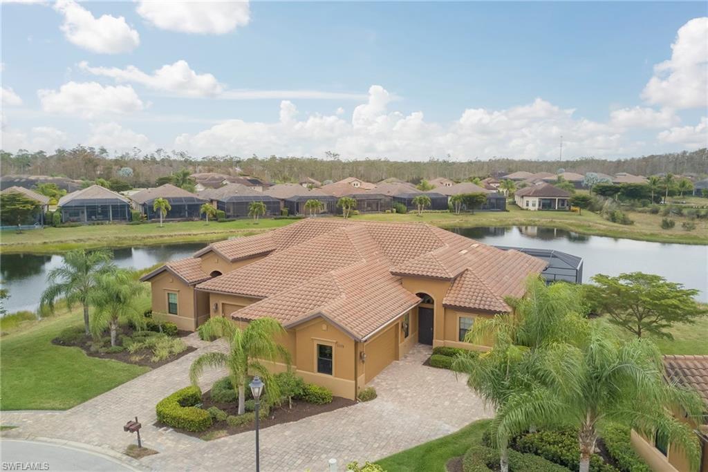 NEW LISTING! Lakefront GRANADA VILLA with Spectacular SUNSET VIEWS and Private RESORT STYLE POOL & SPA, "3 bedrooms plus den & 3 full baths", beautifully upgraded in the highly sought-after, resort-style community of Paseo. Set on a prime lakefront homesite, this meticulously maintained residence blends luxury, comfort, and modern design with exceptional indoor and outdoor living.
The open-concept layout is highlighted by a NEW designer kitchen remodel, featuring top-end KitchenAid appliances, custom cabinetry, stone countertops, upgraded lighting, and wide-plank flooring that flows seamlessly through the main living areas. Thoughtful architectural details and a custom electric fireplace add warmth and sophistication.
The spacious owner’s suite offers a serene retreat with a fully remodeled spa-inspired bathroom, open walk-in shower, dual vanities, and an expansive custom walk-in closet.
Step outside to an extraordinary PRIVATE OASIS. As the sun sets, the lanai transforms into a private retreat, offering sweeping lake views and vibrant sunset skies reflected across the custom pool and oversized spa—creating a showstopping outdoor living space perfect for both tranquil evenings and unforgettable entertaining. The outdoor area is enhanced with LED color-changing pool lights, white marble pavers, picture-window lanai screens, and discreet “invisible” deck drains with floor lighting.
Additional notable upgrades include:  Smart-app-controlled hot water heater, New exterior paint, Landscape lighting front and rear, Designer lighting fixtures and ceiling fans throughout.

Paseo’s luxurious amenities rival any five-star resort: unwind at the stunning lagoon-style pool with TIKI BAR, catch a game at the pub, brunch at the bistro, or enjoy the on-site cinema. Stay active with a fully STATE OF THE ART FITNESS CENTER, six Har-Tru tennis courts, pickleball courts, and a newly added lighted bike path connecting to Lee County’s extensive trail system.Whether you’re seeking an upscale seasonal retreat or a year-round residence, this exceptional VILLA invites you to experience the very best of the Southwest Florida lifestyle. Schedule your private tour today.