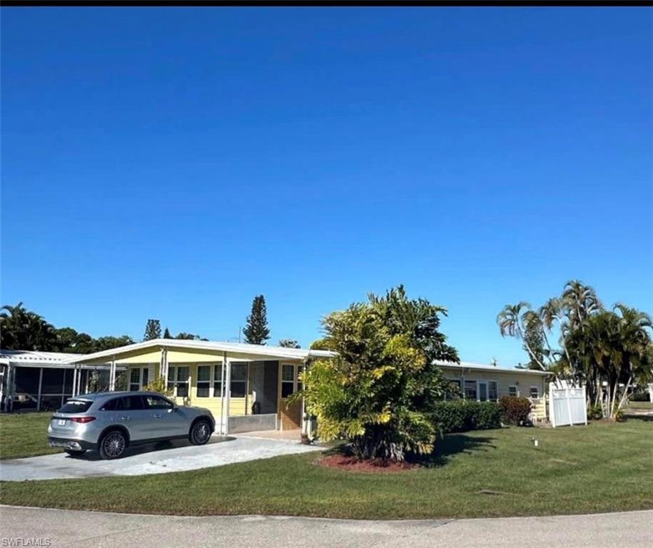 OWNER FINANCING AVAILABLE! Ask the agent about terms.
 Beautiful home in Bonita Springs! 55+ community; you own the land. Situated on an oversized corner lot, this well-maintained 2-bedroom, 2-bath home offers comfortable Florida living with plenty of space both inside and out. The roof and A/C were replaced in 2021; an engineering study was just completed; the foundation is in perfect shape

The home features a bright and inviting floor plan, a covered carport, a dedicated workshop/workbench area for hobbies or storage, and a spacious Florida room perfect for relaxing, entertaining, or enjoying Southwest Florida's sunshine year-round. The oversized corner lot provides added privacy, extra outdoor space, and excellent curb appeal.

Residents enjoy access to community amenities including a clubhouse and sparkling community pool, creating the ideal setting for an active and social lifestyle. Conveniently located near shopping, dining, entertainment, and the Gulf beaches, this property offers the perfect combination of comfort, value, and location.

Don't miss this opportunity to own your piece of paradise in Bonita Springs!