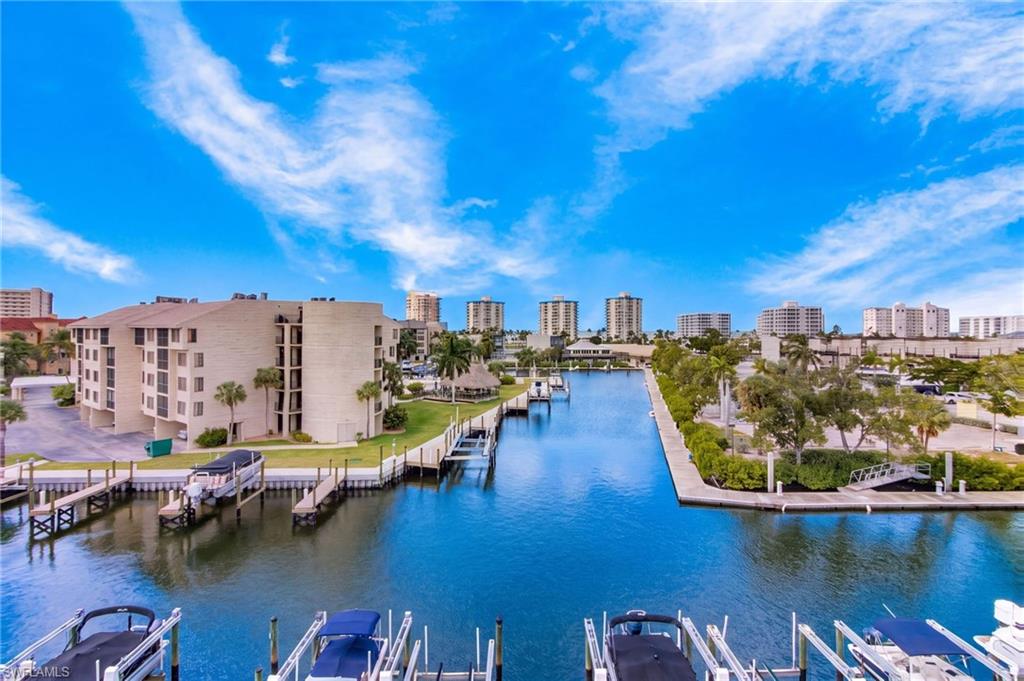 Stunning GULF and CANAL VIEWS from this top floor PENTHOUSE at Royal Pelican condominium on the south end of Fort Myers Beach! This beautifully renovated 2 bedroom, 2 bathroom condo is offered turnkey furnished and features an open, spacious floor plan with two private lanais overlooking the Gulf and the large central canal and marina. Interior updates include granite countertops in the kitchen and both bathrooms, updated cabinetry, crown molding throughout, solid-panel interior doors with nickel hardware, and newer appliances, including a washer and dryer. The spacious primary suite features a private lanai, ensuite bathroom, and large walk-in closet. The guest bedroom also offers a walk-in closet and convenient access to the second bathroom. Additional features include under-building parking and beautiful Gulf sunsets. Royal Pelican is a waterfront condominium community offering Gulf-access boating, two swimming pools, shuffleboard, and a community room. Boat docks may become available for separate purchase. Owners also enjoy Estero Bay Improvement Association (EBIA) amenities, including deeded beach access with parking, tennis, pickleball, bocce, walking paths, and a fishing pier. Conveniently located near Santini Marina Plaza, restaurants, shopping, marinas, and the white-sand beaches of Fort Myers Beach, with Lovers Key State Park just minutes away.