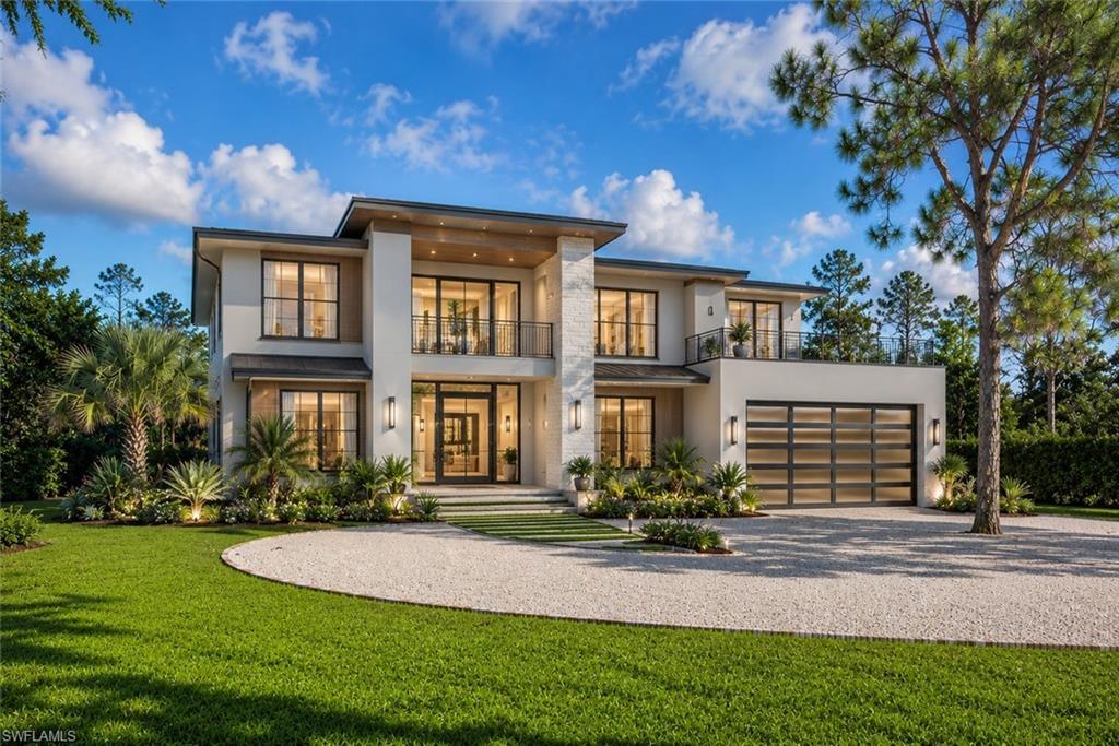 One or more photo(s) has been virtually staged, AI generated or rendered.  Rare opportunity! The first two images are of an architectural rendering, illustrating a couple possible custom homes that could be built on this unique property, and are for inspirational purposes only. An exceptional opportunity awaits in the highly sought-after Pine Ridge Estates. This rare 1.61-acre lakefront homesite offers the perfect setting to build your custom dream estate in one of Naples' most prestigious, no-HOA communities. Ideally located in the heart of Naples, you'll enjoy the perfect balance of privacy and convenience—just minutes from the area's world-famous white sand beaches, upscale shopping at Mercato and Waterside Shops, renowned restaurants, vibrant Downtown Naples, and premier cultural attractions, including the Naples Philharmonic. The property currently includes an older residence being sold As-Is, presenting an outstanding opportunity for builders, investors, or buyers ready to create a one-of-a-kind luxury retreat. With ample space, beautiful lakefront views, and an unbeatable location, the possibilities are truly endless. Don't miss this rare chance to secure an oversized lakefront parcel in one of Naples' most desirable neighborhoods and experience the exceptional Southwest Florida lifestyle at an incredible value.