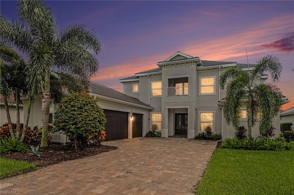 Located in the premier luxury lakefront boating community of Wild Blue, this pool home has 4 bedrooms, 3 full baths, 2 half baths, den, bonus room and a 3-car courtyard garage!  Over 3,500 sq. ft. living area.  Follow the pavered driveway to the 2-story covered entry. The front entry has double doors with decorative glass. Step inside to a dramatic two-story foyer with soaring ceilings, rich wood flooring, and an open, airy layout. The home  features an updated graceful staircase with modern balusters and bannister.  Throughout the home are rich wood floors, tray ceilings with intricate crown molding, recessed lighting and modern light fixtures as well as distinctive arched doorways and niches that add architectural character. On the first floor, 3 sets of expansive southern exposure sliding doors fill the living and family spaces with natural light and provide seamless access to the outdoor living area. To the right of the entry is the den, with wood-framed glass doors and to the left is the formal dining area. The flow leads you forward into the living area, the breakfast nook (with a canted corner window), family room and kitchen.  The kitchen is seamlessly integrated into the family room space.  The kitchen is equipped with abundant tall cabinetry, quartz countertops, a center island and an expansive peninsula, perfect for casual meals.  Stainless steel appliances (including a gas stove with an overhead pot filler) along with a sleek range hood round out the kitchen.  The first floor primary suite has southern exposure windows and a door with direct access to the pool area. The suite has two closets (walk-in & reach-in).  The bath retreat features dual vanities, a walk in shower and a big soaker tub. Upstairs there are three bedrooms and a bonus room with its own private, open air balcony overlooking the pool.  The seller’s enjoyed the bonus space as a media room, complete with room-darkening curtains and beverage center.  This home’s outdoor living area has been transformed into a relaxing private oasis with big, lighted picture window screens, travertine deck and a fire pit table.  Lighted and stepped pool includes an integrated sun pad.  The “Champagne” style spa, with iridescent glass mosaic tile, is a showstopper! The pool/spa are heated by New gas or electric (2021).  The pool, spa and screen enclosure lights are all easily operated with an app!  For al fresco dining or everyday use, the handy outdoor kitchen is complete with built-in gas grill, flat-top griddle, sink, refrigerator and ample storage.  The 3-car garage sports an epoxy floor and there's plenty of storage room.  Amenities include tennis, pickle ball, fitness center with fitness pool, day spa, tennis pro shop, two restaurants, resort pool, power boat/kayak launches, community boat docks and a white sandy beach area with cabanas overlooking the pristine WildBlue Lake.  Community docks available for lease. This is Florida relaxed luxury living!