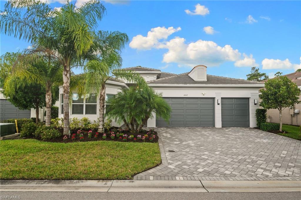 Strategically selected by its original owners for its oversized homesite, desirable southern exposure, and private preserve backdrop, this meticulously maintained Julia floor plan presents an opportunity rarely found in Valencia Bonita. Offering 2,878 square feet with 3 bedrooms plus a den, 3 en suite bathrooms, a separate powder room, and a 3-car garage, this residence distinguishes itself through custom finishes, thoughtful enhancements, and exceptional outdoor living space. The expansive covered lanai, enhanced by an extended roofline, upgraded pavers, and a Storm Smart motorized screen, overlooks a protected preserve and an unusually generous backyard offering privacy and possibilities for future outdoor enhancements. The home's striking front elevation, bay windows, and custom double-glass entry doors establish its distinctive character. Rather than settle for standard builder offerings, the original owners strategically opted for credits on flooring, appliances, and backsplash selections to incorporate premium finishes beyond the builder's available options. The thoughtfully appointed kitchen features a Bosch dishwasher, double oven, soft-close cabinetry, pull-out storage, custom backsplash, and a highly desirable secondary vegetable/prep sink in the island. A built-in wine refrigerator in the main living area adds convenience for entertaining. Interior details include designer lighting, custom wallpaper and feature walls, custom barn doors, Hunter Douglas automated Pirouette and Silhouette blinds, tailored drapery, and thoughtfully designed closets. The primary bathroom offers a spa-inspired experience with a custom walk-in shower, rainfall showerhead, frameless glass enclosure, and oversized framed vanity mirrors. The separate powder room is a sought-after convenience, allowing guests to enjoy their own facilities without entering the private bedroom suites. A dedicated den with custom office built-ins and an enhanced laundry room with upgraded washer and dryer and a second refrigerator further distinguish this residence. Additional investments include a whole-home generator, upgraded A/C, water softener, hurricane-impact glass, Sonos in-ceiling speakers, integrated smart-home technology, a Ring alarm system with cameras, and a finished three-car garage with storage cabinetry. Valencia Bonita is one of Southwest Florida's premier 55+ natural gas communities, offering a 45,000-square-foot clubhouse and a resort-style lifestyle. Residents enjoy multiple swimming pools, a full-service restaurant and bar, state-of-the-art fitness facilities, pickleball, tennis, bocce, a spa and nail salon, and an extensive calendar of social events, clubs, and live entertainment coordinated by a dedicated lifestyle team. Conveniently positioned near Gulf beaches, shopping, dining, and everything Bonita Springs has to offer, this exceptional residence combines a rarely available homesite with quality and attention to detail for discerning buyers.