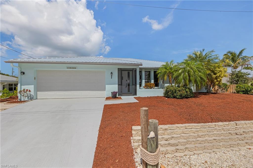 Welcome to your dream home in Bokeelia! Waterfront canal home with easy and fast access to Charlotte Harbor and the Gulf of Mexico.  A boater and fishermans paradise.  This stunning single family home boasts 3 bedrooms, 2 bathrooms, and a 2 car garage, making it the perfect oasis for you and your family. The interior features fresh new paint,  granite counters, tile flooring, and an open concept layout with a large island and dining area, perfect for entertaining guests.  The raised elevation ensures peace of mind, as this home has never flooded. 

Step outside to enjoy the newly painted exterior, newer AC, and a Generac generator with 3 250 lb propane tanks, providing added convenience and security. The outdoor space is equally as impressive, with a boat lift, large concrete dock area, and zero landscape with rock and mulch. A fenced area for pets adds to the appeal of this property, making it the perfect place to call home. Located in desirable Bokeelia at the north end of Pine Island, this home truly has it all. Don't miss out on the opportunity to make this your own slice of paradise - schedule a showing today!