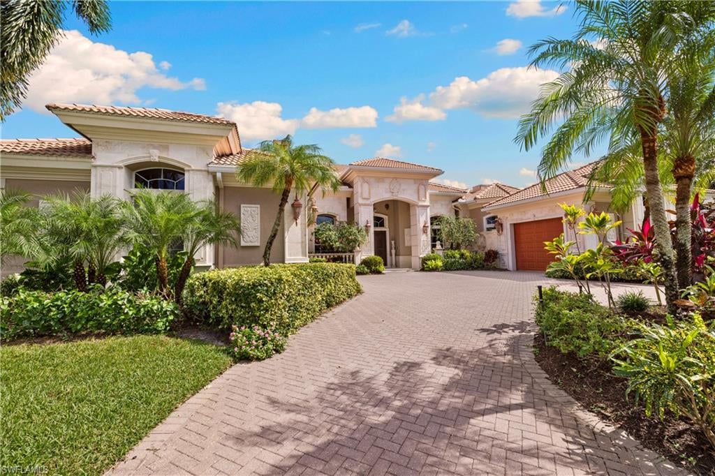 Tucked within Terracina, one of Vineyards’ most distinctive enclaves, this custom-built estate offers over 4,500 square feet of gracious living, remarkable architectural detail, and sweeping views across the lake. Its timeless Mediterranean architecture and thoughtfully designed interiors reflect a level of craftsmanship and individuality rarely encountered today. A dramatic entry with rich mahogany doors introduces soaring ceilings, elaborate millwork, elegant marble flooring, and beautifully proportioned formal living spaces. The thoughtfully designed floor plan offers four ensuite bedrooms and a private office, with generous gathering spaces that accommodate both entertaining and everyday living. The secluded primary suite is a retreat of its own, featuring wood flooring, a fireplace, an expansive bath, and generous walk-in closets. Two guest suites offer comfortable accommodations and privacy, while the versatile fourth ensuite bedroom, with direct access to the outdoor living area, can easily serve as a media room, recreation space, or additional guest retreat. Outdoor living is equally compelling. An expansive covered lanai, heated pool and spa, and outdoor bar create an inviting setting for entertaining or simply enjoying the peaceful lakefront backdrop. An added bonus: the outdoor living area is equipped with Kevlar hurricane protection screens. Residents of Vineyards enjoy a beautifully established community with optional membership opportunities at Vineyards Country Club, offering golf, wellness, dining, and social amenities. Golf memberships are currently available without a waitlist, subject to club confirmation.With homes in Terracina seldom available, this is a rare opportunity to own a residence distinguished by its generous scale, architectural personality, and exceptional setting.