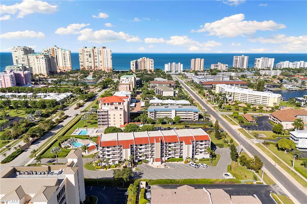 Discover effortless island living at Casa de Marco, where comfort, convenience and an exceptional location come together just 0.3 miles from Marco Island's beautiful white-sand beaches. Offered turnkey-furnished, this inviting three-bedroom, two-bath condominium is thoughtfully appointed with quality furnishings and beautifully coordinated décor, creating a welcoming coastal retreat where all that's left to do is pack your bags and settle into paradise.  The spacious, well-designed floor plan features split bedrooms for added privacy, generous closet space, and comfortable living areas ideal for relaxing or entertaining. An updated kitchen and baths provide a fresh, inviting feel, while an in-unit washer and dryer add everyday convenience. Go outside to the generously sized screened lanai, where glimpses of the Gulf and beautiful sunset views create the ideal backdrop for evening relaxation or entertaining. Electric shutters throughout offer added protection and peace of mind, making seasonal ownership that much easier. Additional conveniences include desired covered under-building parking and a spacious private garage-level storage closet, ideal for beach chairs, bicycles and all your island essentials. A community swimming pool completes the relaxed Florida lifestyle. With beach access just a short stroll away and monthly rentals permitted, this residence offers exceptional flexibility as a full-time home, seasonal retreat or investment opportunity. Beautifully furnished, ideally located and ready to enjoy from day one, this is Marco Island living made easy.