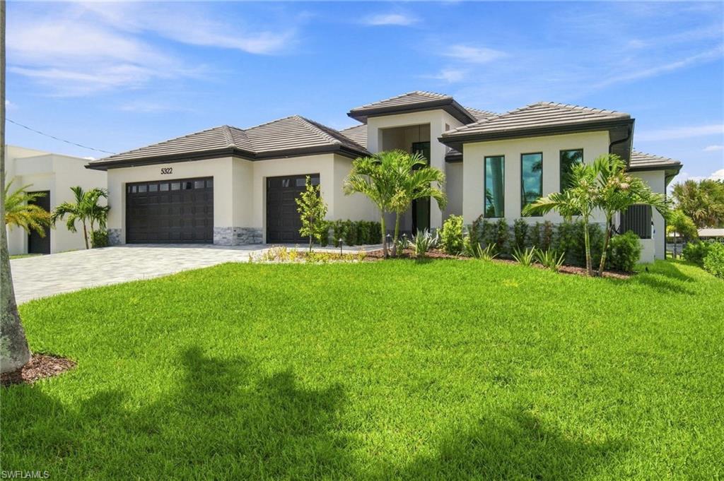 Experience refined waterfront living in Cape Coral’s sought-after Yacht Club area with this newly constructed luxury residence offering western exposure and direct, no-bridge access to the Caloosahatchee River and Gulf waters. With approximately 2,780 square feet under air and more than 4,000 total square feet, the home features four bedrooms plus a den, four full baths and a powder room, all thoughtfully designed for both everyday comfort and entertaining.

A soaring entry introduces the expansive main living area, where dramatic ceiling heights, 90-degree corner sliders and a sleek porcelain fireplace wall create a bright, modern atmosphere. Designer finishes carry throughout the home, while stone accents on the exterior add warmth and architectural character to the contemporary facade.

At the center of the home, the chef’s kitchen combines function and style with custom cabinetry extending to the ceiling, illuminated glass display cabinets, quartz surfaces, a large center island, walk-in pantry and premium stainless-steel appliances. The gas cooktop may also be converted to induction for added flexibility.

The owner’s suite offers a private escape with dual walk-in closets and a beautifully appointed bath featuring separate vanities, a freestanding soaking tub and an oversized walk-in shower.

Outdoor living is equally impressive. The screened lanai opens to wide canal views and colorful western sunsets, with an infinity-edge heated pool and spa with smart controls, dual fire bowls and a complete outdoor kitchen with a connected Blaze gas grill. A concrete dock and substantial seawall complete the waterfront setup, creating an ideal setting for boating and enjoying life on the water.

Additional highlights include impact-resistant windows and doors, upgraded landscaping, Level 5 smooth walls, wood-look plank tile flooring, a reinforced five-course stem wall foundation, reinforced concrete seawall tie-backs, a recently refinished concrete dock, an underground 250-gallon propane tank, and a three-car garage with epoxy flooring and insulated ceilings.

Conveniently located near waterfront restaurants, downtown Cape Coral and the Fort Myers riverfront, this exceptional new residence combines sophisticated design, outstanding boating access and the relaxed luxury of Southwest Florida waterfront living.