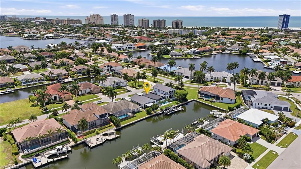 Have you ever dreamed of living the good life on Marco Island? Now is your chance to make that dream a reality.
Perfectly positioned on a coveted .37 acre oversized corner lot, 910 Beaver Court offers the ultimate in coastal living. With one bridge to the Gulf and Marco Island’s private residents’ beach just a five minute walk away, this exceptional waterfront residence combines an enviable location with unparalleled luxury and convenience.
Boasting just over 4,600 square feet under air, this fully remodeled, custom built six bedroom, five bath home features two primary suites and was thoughtfully designed for effortless everyday living and sophisticated entertaining. Premium craftsmanship, high end finishes, and timeless contemporary design are showcased throughout, creating an atmosphere that is both refined and inviting. The expansive outdoor living spaces are truly spectacular, centered around a stunning pool and spa overlooking the canal. A generous covered patio provides the perfect setting for year round entertaining, complete with an outdoor kitchen and dining area.
With more than 110 feet of water frontage, the private dock is designed for the boating enthusiast, featuring a hydraulic lift accommodating a boat up to 32 feet, along with a separate floating dock ideal for a small powerboat, kayak, or jet ski. In regards to safety and insurability, the house offers all impact doors and windows, a propane powered generator, and an interlocking standing seam 2025 metal roof. From its exceptional location and boating access to its beautifully updated interiors and remarkable outdoor spaces, every detail of 910 Beaver Court comes together to create a waterfront home that is as impressive as it is inviting. Luxury, location, and the Marco Island lifestyle — all in one extraordinary property.