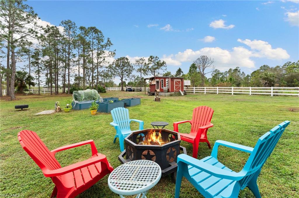 Welcome to this beautifully updated 3-bedroom plus den, 2-bath home with 2020 Sq Ft.This beautiful property is perfectly set on 3.78 Acres and surrounded by a New white rail vinyl fence on the perimeter, a crossed fence for horses and double wide gate with solar lights at the entrance! A rare gem, located in desirable Naples, Florida and move in ready with all new flooring throughout, New kitchen cabinetry and Island, granite countertops, white tile backsplash, All New kitchen appliances including washer and dryer, New interior doors and baseboards, New bathroom vanities and mirrors, custom closets, New outlets with USB C, Front impact rated door and new exterior paint too! The property has been cleared with plenty of room for gardening, animals, and outdoor activities! No HOA rules or fees—here, you’re free to make this home your own. Located in peaceful Golden Gate Estates, you’ll enjoy country living with all the conveniences of nearby PUBLIX, shopping, schools and amenities. Don’t miss your chance—schedule a private viewing today and step into your dream estate!