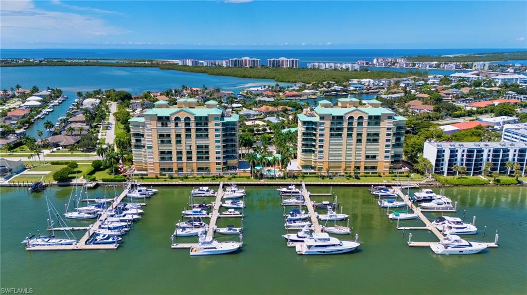 Experience exceptional waterfront living from this 7th-floor residence at Pier 81. This 3-bedroom, 2-bath split floor plan showcases spectacular panoramic views in both directions, with breathtaking sunrises over the Marco River and Jolley Bridge from the expansive east-facing lanai and gorgeous sunsets over Marco Island and the Gulf from the west lanai. From the moment you walk through the door, the views take center stage.
Beautifully maintained and upgraded, the residence features a brand-new A/C system, new sliding-door tracks, a custom kitchen with stainless steel appliances, built-in bar with granite-top table, wall-to-wall entertainment center, custom lighting, and a versatile third bedroom with a built-in office and queen Murphy bed. Electric and manual storm shutters provide added convenience and protection. Offered beautifully furnished, Unit 702 is ready to enjoy from day one.
A prime under-building parking space is protected from the elements by the back wall and conveniently located just steps from the elevator. Pier 81 offers two pools and spas, a fitness center, sauna, tennis courts, climate-controlled storage, and a private marina on Factory Bay with boat slips available for lease or purchase. Ideally situated in Olde Marco, the residence is just minutes from Marco Island’s beautiful beaches and within walking distance of neighborhood favorites including Snook Inn, Marek’s, and The Boardroom Tavern.