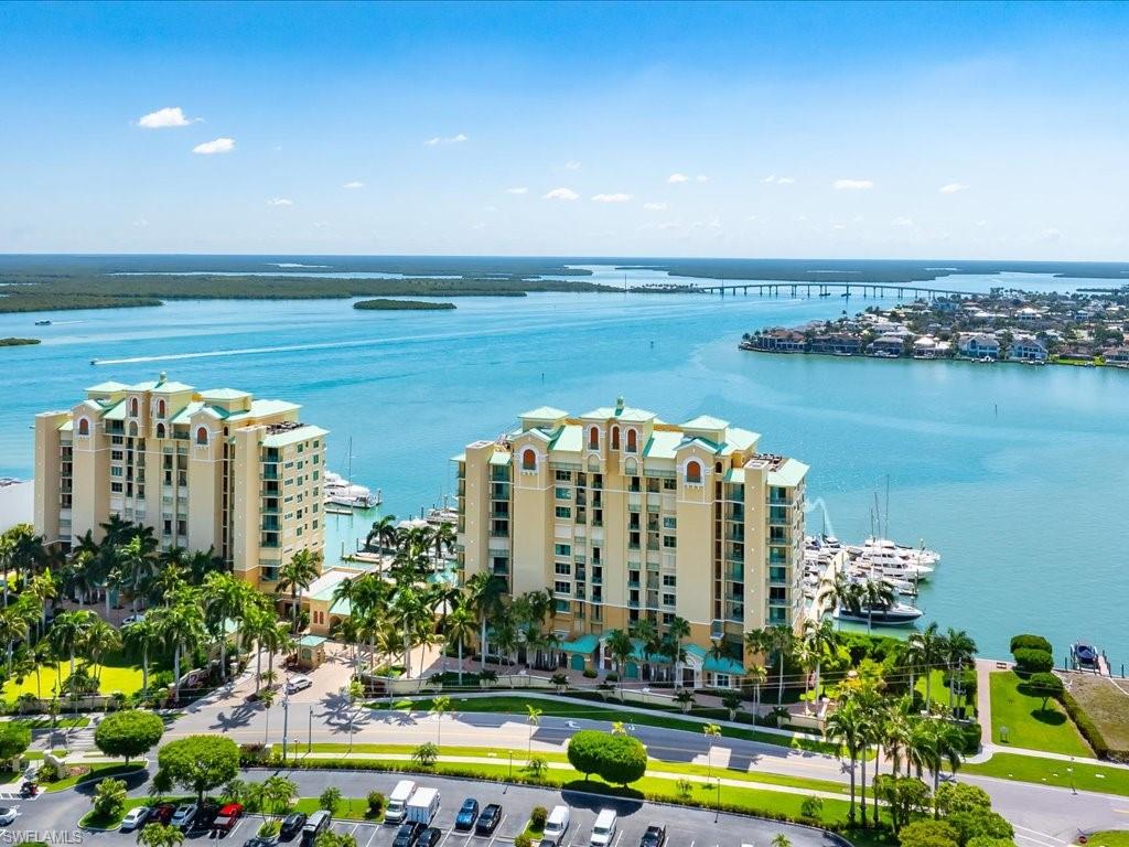 Your waterfront backyard awaits at Pier 81. This light-filled fourth floor end unit blends indoor-outdoor living with a massive lanai overlooking the Marco River—ideal for morning coffee during sunrise.  This 3 bedroom (2.275 Sq Ft) home offers majestic, 360-degree views of the Marco River, the Gulf, and the pools, allowing you to witness both sunrises and sunsets from three balconies. The open-plan living area flows effortlessly into a custom kitchen, while the massive Primary Suite and two guest rooms each enjoy the luxury of a private lanai. Whether you're hosting at your outdoor kitchen or watching yachts glide by the lifestyle here is unparalleled. Experience resort living at Pier 81: two sparkling pools, clay tennis courts, a modern gym, and a relaxing sauna, beautifully landscaped social spaces and a vibrant, friendly atmosphere in the heart of Marco Island. Schedule your private tour today!