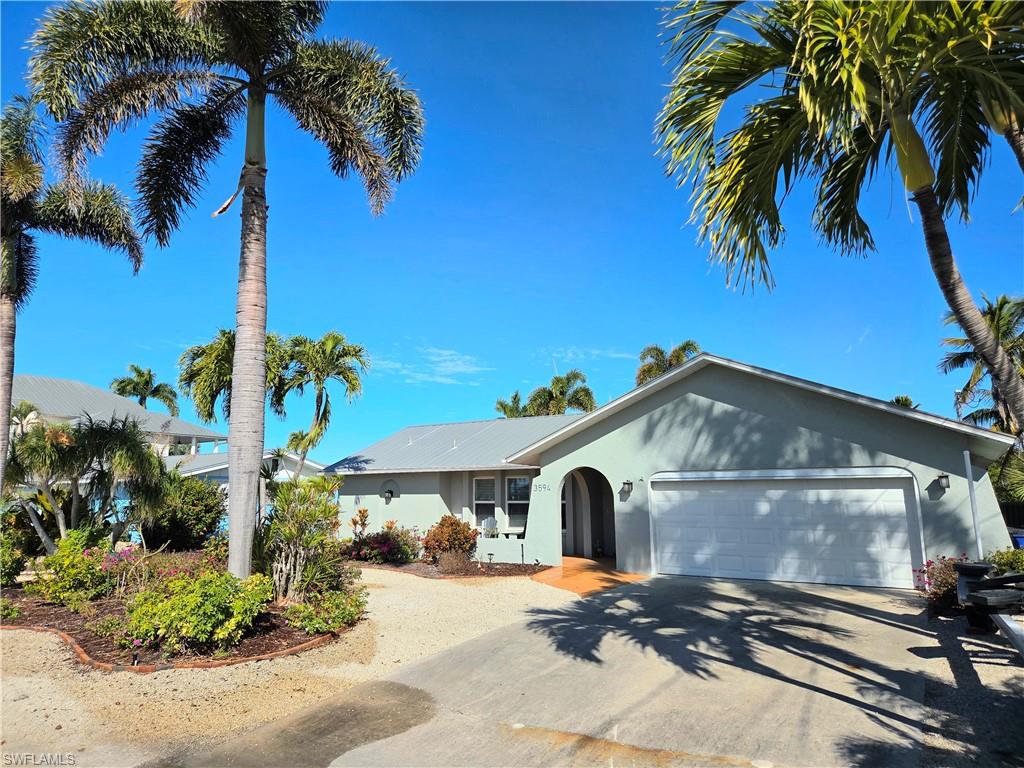 Come see this very pretty home located on the 2nd canal in from the bay which takes just a couple of minutes ride to San Carlos Bay, and ten minutes more to Sanibel Island by boat. Great location in St. James City on Pine Island in the beautiful Bayview neighborhood. This 3 bedroom, 2 bath home was completely remodeled after Hurricane Ian. 1,550 square feet PLUS an approximately 400 square foot sun room (with portable AC included) on the canal side and another 400 square foot travertine patio that leads to the boat lift. The interior is completely tiled, even the sun room. You will love the low maintenance yard that has beautiful gardens and palm trees. The home boasts a new HVAC with a raised outside unit, plus a 3 zone irrigation system with timer. The kitchen has stainless steel appliances that will remain. All windows and doors are impact resistant. No flooding inside during last 2 storms.  This s is a great waterway neighborhood with easy to reach beaches and restaurants by boat. There are great and fun restaurants nearby that are golf cart or bicycle distances away when you are not boating to Sanibel, Captiva, Cayo Costa or Cabbage Key. This is such a great location for boaters. Oh, and the Manatees love this canal. You can sit down by the canal on the beautiful area with easy care artificial turf watching all the wildlife. The boat lift has a new, all aluminum cradle with new cables as well. You're going to love this house. MAKE AN APPOINTMENT TO SEE IT TODAY?!