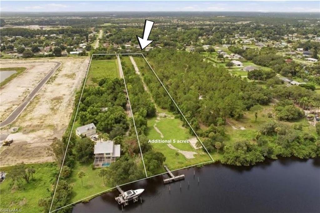 Rarely available, this 5+--acre waterfront property sits in one of the most desirable locations along the Caloosahatchee River. Boaters will love the large dock with water and electricity already in place. The property also includes a private drive, large concrete slab, and 50-amp electrical service run to the dock. Also, has a 30-amp RV plug-in, ready for your future home or garage. Enjoy the privacy of acreage while staying close to everything: just 15 minutes to I-75 and Babcock Ranch, and 20 minutes to downtown Fort Myers. Five-acre waterfront parcels in this area are extremely hard to find. Don't miss your chance to own one! Need more land? **** Adjacent 5-acre pool home to the east is also available from the seller to combine as a 10ac estate. (13668 Marquette)