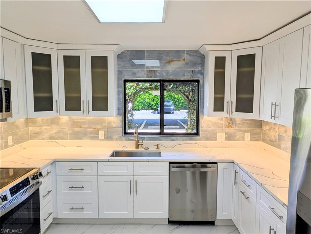 Completely updated and reimagined 3-bedroom 2 bath, FIRST FLOOR residence that offers a fresh and quite modern lifestyle; this home is better than new and is move in ready.  Features include all NEW quartz countertops, plumbing fixtures, bathtub, bathroom tile, glassed in tub and shower, light fixtures including under cabinet kitchen lightning, interior doors and hardware, baseboards, screens, glassed in screened lanai,3-month-old A/C system, porcelain tile flooring, electrical switches and outlets, white shaker style kitchen & bathroom cabinets.  A Single Carport is right out the front door and an adjacent storage closet.  Walk to Mercato and just minutes to those nearby white sandy beaches, Gulf of America, movie theater, neighborhood shopping and restaurants.  Positioned in Summerplace that provides a quite west facing glass enclosed lanai providing year around enjoyment and a stunning view of those amazing sunsets, the landscaped area, community pool and BBQ area.