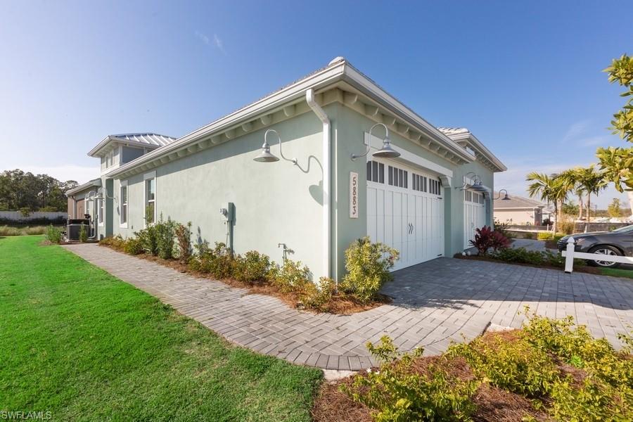 The Dahlia is now available in the pristine nature-influenced community of The Isles of Collier Preserve by Minto Communities. Surrounded by nature, embraced by luxury and just minutes from Downtown Naples and the beaches, this beautiful 2,211 sq. ft. Villa has 2 Bedrooms, 2 Bathrooms, Den, 2 car Garage. The Isles of Collier Preserve captures the timeless architecture and traditions of Old Naples. Over half of the 2,400 acres are lakes, nature preserves and natural habitat. Elegant single-family, villa and coach homes overlook miles of scenic kayak and biking trails along the tranquil Cypress Waterway. Visit our interactive Discovery Sales Center and experience this one-of-a-kind community for yourself! The Isles Club has a Fitness Center, Resort-Style Pool, Tennis, Pickle Ball, Hiking & Biking Trails, Two Kayak Launches and 8 Miles of Kayak, Paddle Board, Catch & Release Fishing and the OVERLOOK BAR & GRILL!!! *Photos are of model, not home being sold.*.