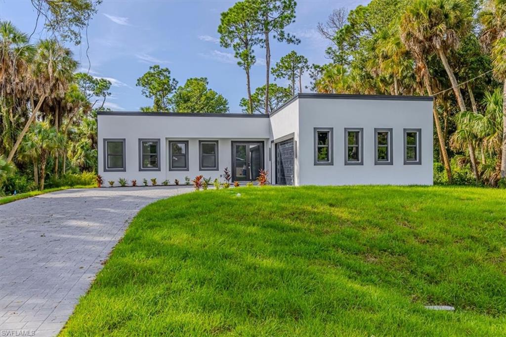 Experience modern luxury in this beautifully designed custom home, where sophisticated style meets thoughtful functionality. From the striking contemporary exterior and expansive paver driveway to the clean architectural lines throughout, every detail has been carefully selected to create a refined yet inviting residence. Step inside to a bright, open-concept layout enhanced by large-format tile flooring, high ceilings, recessed lighting, sleek black accents, and abundant natural light.
The designer kitchen serves as the heart of the home, featuring elegant cabinetry, quartz-style countertops, stainless-steel appliances, a spacious center island, modern pendant lighting, and contemporary black fixtures. The seamless connection between the kitchen and living areas creates an ideal setting for both everyday living and entertaining.
The primary suite offers a private retreat with a beautifully appointed spa-inspired bathroom featuring a freestanding soaking tub, oversized walk-in shower, dual vanities, modern fixtures, and sophisticated tile finishes. Additional upgrades elevate the home even further, including a whole-home water treatment system with reverse osmosis, a fully finished garage with durable epoxy flooring, modern lighting and fixtures, generous storage, a dedicated laundry area, and thoughtfully selected finishes throughout.
Large windows and sliding glass doors bring in abundant natural light while connecting the interior to the surrounding Florida landscape. A distinctive custom residence offering contemporary architecture, quality finishes, upgraded systems, and a level of design that truly sets it apart from the ordinary. MORE PICTURES COMING SOON.