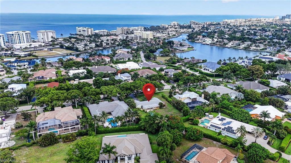 EXCEPTIONAL OPPORTUNITY, RARE FIND IN "COQUINA SANDS" SPACICIOUS 1/2 ACRE LOT ON CRAYTON ROAD! Walk to the beach from your spacious Coquina Sands half-acre luxury home lot! The home and property are being sold 'as-is' for land value and location only. The property fronts prestigious tree-lined Crayton Road and is  within EASY WALKING DISTANCE TO NAPLES FAMOUS WHITE SAND BEACHES AND THE NEW FOUR SEASONS BEACHFRONT RESORT. This hard-to-find "OVERSIZED" lot is ideal for luxury home builder, investor, or buyer looking to create a custom dream home. PROPERTY HAS IT'S OWN WELL FOR IRRIGATION AND HAS A HIGHER PROPERTY ELEVATION THEN THE AREA IN GENERAL, SO A LOT LESS FILL REQUIRMENT! Imagine building your dream home just steps from the beach as well as close proximity DOWNTOWN 5TH and all of the best of OLD NAPLES offering upscale shopping, fine dining, and cultural venues. Few opportunities like this remain in Coquina Sands.  This property is for the most discerning buyers and presents a rare chance to design and build in one of Naples' most desirable neighborhoods.