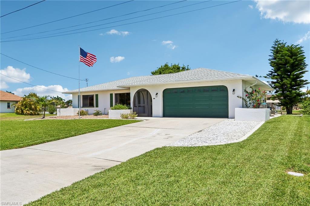 Very well maintained 3-bedroom, 2-bath home with Gulf access. CBS construction, new porcelain plank tile throughout, remodeled kitchen with quartz countertops, glass tile backsplash, and new cabinetry. Both bathrooms updated with new tile, flooring, and vanities. The living room features a cathedral ceiling, adding to the open feel of the main living area. Outside, the property offers a large screened lanai with an extended patio, paver pad with tiki hut, and a putting green, along with a spacious backyard with mature landscaping and plenty of room to add a pool. The waterfront includes a concrete dock and 10,000 lb boat lift, with just one bridge to open water — only 5 minutes to the Outer Rim Canal (South Spreader). Additional features include a generator hookup, an updated four-zone sprinkler system, and a roof replaced in 2023. The home has not experienced flooding or flood damage. Assumable Flood insurance policy and elevation certificate available. A great opportunity for boaters looking to enjoy the water and outdoor Florida lifestyle. Schedule your showing today.