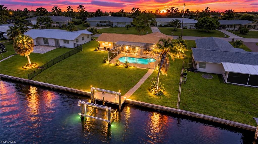 One or more photo(s) has been virtually staged, AI generated or rendered.  GULF ACCESS, HEATED SALTWATER POOL, NO RENTAL RESTRICTIONS & ALL ASSESSMENTS PAID IN DESIRABLE SOUTH CAPE CORAL! Whether you're a first-time homebuyer, searching for your Florida vacation getaway, looking for a waterfront primary residence, or seeking your next income-producing investment, 5224 Tower Drive checks ALL the boxes! Located in the heart of SOUTH CAPE CORAL, just minutes from downtown Cape Coral's popular restaurants, shopping, nightlife, and entertainment, this 2-bedroom, 2-bath waterfront home offers the perfect combination of LOCATION, LIFESTYLE, and INVESTMENT POTENTIAL! Boating enthusiasts will appreciate the NEW COMPOSITE DOCK, 10,000-LB BOAT LIFT, AND DIRECT GULF ACCESS, with approximately 15 MINUTES BY BOAT TO THE RIVER AND 25 MINUTES TO THE GULF! Spend your mornings exploring Southwest Florida's beautiful waterways, afternoons relaxing around your private HEATED SALTWATER POOL, and evenings enjoying the waterfront views from your own backyard oasis. Inside, you'll find FRESH NEW PAINT, updated major components, a bright and inviting floor plan, and a spacious FLORIDA ROOM overlooking the pool and canal, providing additional space for relaxing, entertaining, or enjoying the Florida lifestyle year-round. Even better, this home features CITY WATER & SEWER WITH ALL ASSESSMENTS PAID, offering added value and peace of mind! INVESTORS, TAKE NOTICE! With NO RENTAL RESTRICTIONS, desirable boating amenities, a private heated pool, and a sought-after South Cape Coral location, this property offers excellent potential for short-term, seasonal, or long-term rental income. Looking for a vacation home? Enjoy your own waterfront retreat while having the flexibility to generate rental income when you're away! First-time buyer or searching for your forever home? Enjoy the benefits of waterfront living, updated features, and an unbeatable location without sacrificing convenience. Just minutes from downtown Cape Coral, waterfront dining, shopping, entertainment, and everything that makes Southwest Florida such a desirable place to call home. LIVE IN IT, VACATION IN IT, RENT IT OUT, OR INVEST IN YOUR FUTURE—THE CHOICE IS YOURS! And as an added bonus, A 2006 COBIA BOAT MAY BE INCLUDED WITH AN ACCEPTABLE OFFER! Don't miss this opportunity to own a versatile Gulf-access waterfront property in one of Cape Coral's most desirable locations.