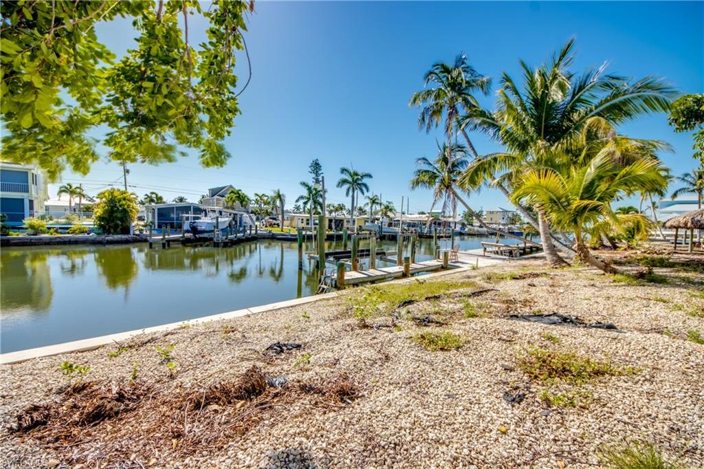 Bring your Sailboat.. ! Intersecting canals, seconds from Open water and San Carlos Bay. Seawall, Dock with lift. Once sold you won't have this opportunity to purchase this type lot and build YOUR home so close to San Carlos Bay, there isn't any more left.!! This lot was part of a 3-lot Estate and Lot-11 is now for sale !!! the other two lots, 12 & 13 are also for sale, Lot 12 has a Single Family Residence on it...At this Location, at this price and before it's gone, Please check this property out NOW !!!!
