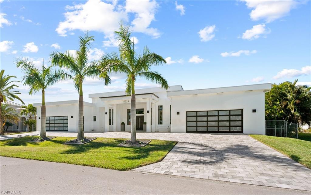 YACHT & SAILBOAT ACCESS! Ultra-luxury, CUSTOM BUILT, infinity edge pool Home. Private DOCK can accommodate a yacht, sailboat, providing effortless access, No bridges, no delays, just waterfront freedom. Oversized .34 acre lot, 4,349 Sq. ft., 3 Bedrooms, multiple en suites, Den/Office, 4 full baths including pool access & half bath. Retreat to the lavish primary suite with water views, en suite bath and attached workout room/flex space. The modern gourmet Quartz Kitchen features high-end appliances & cabinetry, an oversized island and seamless indoor/outdoor flow. Every detail of this home has been thoughtfully curated to deliver unrivaled comfort, elegance and coastal luxury. Perfectly positioned & designed for those who prefer open-concept living with 16 ft. ceilings, high-end finishes & entertaining. Impact glass throughout, electric, remote controlled shutters and custom awnings. Designer finishes, smart home features and 12-foot impact sliding glass doors throughout make this home truly one of a kind. Marble tile lines the resort-style, fully screened outdoor oasis. Enjoy a sparkling infinity-edge pool, spa, multiple lounge areas and seating with fire pit, overlooking the wide canal and stunning Western exposure sunsets. Lights will illuminate in the evening. Outdoor Granite propane-powered kitchen. Multiple A/C units, oversized, 4+ garage spaces under air & commercial grade doors. Perfect for car enthusiasts and collectors. This is more than a Home. It is where modern elegance meets waterfront living. A perfectly unique design and direct water access in one of Cape Coral’s most coveted waterfront locations.