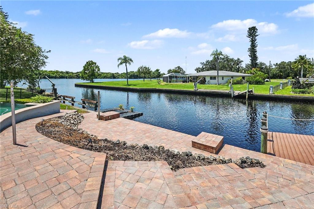 GORGEOUS RIVER VIEWS, EXCEPTIONAL BOATING & A FANTASTIC KITCHEN! Riverfront living in Alva with 175 feet of waterfront, privacy, and an outdoor lifestyle that is hard to replicate. Located in desirable River Oaks, this updated 3-bedroom, 2-bath home offers nearly 2,000 square feet of living space, spectacular views of the river west of the Franklin Lock, and a property that has never flooded.

The open floor plan seamlessly connects the living, dining, and fantastically updated kitchen, making it ideal for everyday living and entertaining. Renovated in 2022, the kitchen features gorgeous dolomite countertops, a soapstone farmhouse sink, and stainless-steel appliances. Large hurricane-rated sliders open the living area to the screened lanai, infinity pool, and breathtaking river views.

The outdoor space is designed for enjoying the Florida lifestyle. The infinity pool features a heater and chiller added in 2023, while more than 2,000 square feet of tiered pavers provide plenty of room for dining, entertaining, and relaxing. The fenced yard adds privacy and usable space.

Boaters will love the 175 feet of waterfront, including a 7,500-lb boat lift with a 24-foot slip, a dock for two jet skis, and room to add another dock for a boat up to approximately 40 feet. Located west of the Franklin Locks, you can head out on the water for the day, then return home to watch dolphins, manatees, and eagles from your own backyard.

Major updates include a 2022 metal roof, 2023 A/C, 2023 water heater, updated ductwork, and new hurricane sliders. The home has never flooded, and an assumable flood policy is currently under $1,700/year.

Whether you're looking for a full-time residence, family gathering place, or private riverfront retreat, this Alva property delivers gorgeous views, exceptional boating, a fantastic kitchen, and outstanding outdoor living in the peaceful River Oaks community.

BE SURE TO WATCH THE VIRTUAL TOUR for a walkthrough of the entire property.