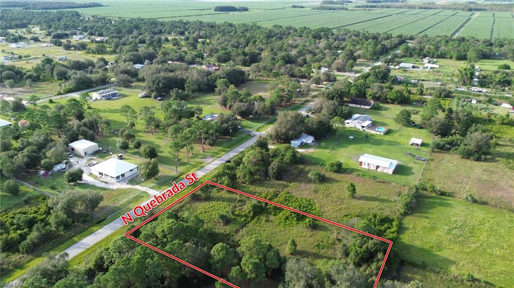 1.25 acre for sale off paved road Quebrada between Pine Cone Ave and Bald Cypress Ave. Property has some partly cleared with some Oak and Pine trees. Fenced in. Will need septic, culvert and well. Electric nearby. This 165ft frontage and back by 330ft length is located in Montura Ranches, a rural horse and golf-cart friendly community that allows for Single and Double Wide Manufactured Homes, Modular and Site-Built homes. Pay no city taxes. Only 25 min from the City of Clewiston, 1.5hr from each coast. Enjoy rural living with your animals and horses and still enjoy the community's clubhouse and pool house free of charge, convenience stores and parks. Call or text your offers in today!