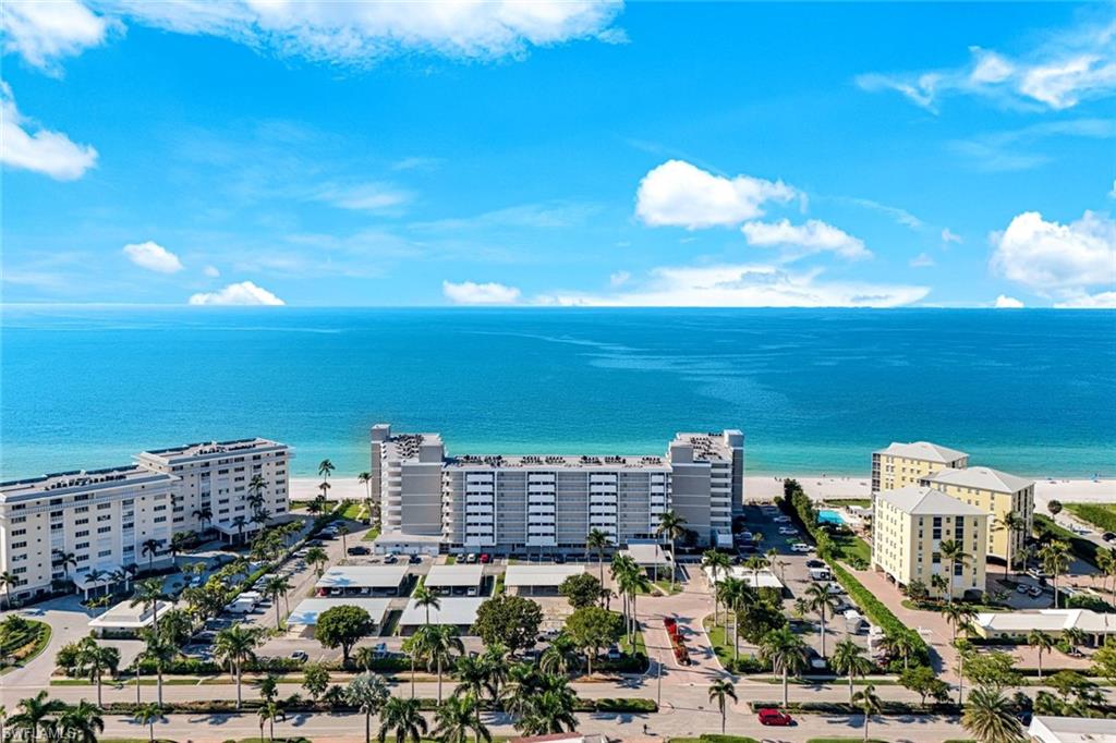 Experience the ultimate Naples beachfront lifestyle in this beautifully updated 2-bedroom, 2-bathroom residence at the prestigious Naples Continental Club. Perfectly situated on the 3rd floor, this west-facing unit offers sweeping, unobstructed views of the Gulf of Mexico, ensuring you never miss a spectacular sunset. The heart of the residence is the renovated kitchen, featuring a sleek waterfall quartz countertop and modern appliances that blend style with functionality. The floor plan is thoughtfully arranged for comfort, offering a spacious primary suite with a King-sized bed and a guest room appointed with two twin beds. Residents of the Naples Continental Club enjoy top-tier amenities, including a beachfront heated pool, chickee huts with BBQ grills for al fresco dining, a fitness center, and a 24-hour staffed front desk. Located in the desirable Moorings neighborhood, this property is just minutes from the upscale dining and shopping at Venetian Village and the world-class entertainment of 5th Avenue South.