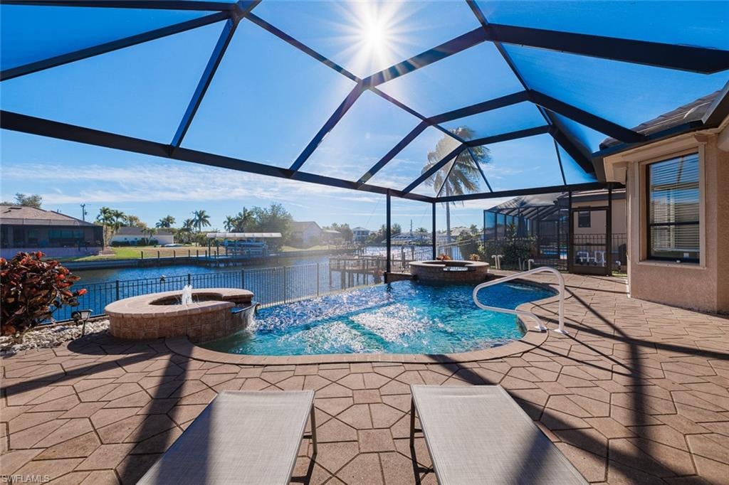 Located in a highly sought-after area of Southwest Cape Coral, this 2,500+ square foot Gulf access pool and spa home offers an exceptional combination of size, features, and location. Built in 2004 and situated on a 150-foot-wide canal with quick Gulf access, the outdoor living area checks all the boxes, featuring an infinity-edge pool with spa and fountain, expansive paver lanai, and a large covered entertaining space. The canal and dock setting provide wide water views and a true Florida waterfront lifestyle, while the fully fenced yard adds both privacy and functionality. The home features three bedrooms plus a large den (currently used as a fourth bedroom), 2.5 baths including a convenient pool bath off the family room, and multiple living spaces designed for comfortable everyday living or entertaining. Recent upgrades include a beautiful tile roof and Daiken A/C system, both approximately one year old, a new lanai in 2024, along with newer pool heater, pool pumps, and appliances offering peace of mind and reduced near-term expenses. Additional peace of mind comes from knowing this property has never flooded in any hurricane. Additional highlights include a paver driveway, generous interior layout, and a turnkey furnished sale, making the home rental-ready for buyers seeking a vacation rental or a ready-to-go seasonal residence. The location is equally compelling, with just one turn and a few blocks to popular dining such as The Lobster Lady, and only minutes to Cape Harbour, shopping, and entertainment. Notably, this property represents the lowest-priced Gulf access pool home over 2,500 square feet in the southernmost part of Cape Coral with a full 80 feet of water frontage. This combination of size, condition, features, and quick boating access makes it a rare opportunity in today’s market.