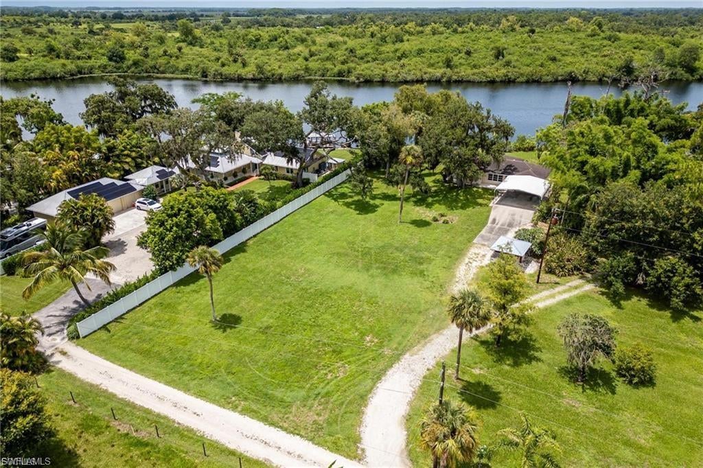 Enjoy Intracoastal riverfront living in the historic Ft. Denaud area with 131+/- feet on the river on 1.03+/- acres! Located on the banks of the Caloosahatchee River, with deep water access to The Gulf of Mexico, Atlantic Ocean, and Lake Okeechobee, this property is protected from storm surge and tides by locks. The home has been a tranquil winter getaway for many years and it is ready for new owners to enjoy! Located just outside of the city limits in one of the nicest parts of the LaBelle area, the cozy home is perfect as a winter retreat, weekend getaway, or the waterfront home you have always dreamed of. The home has amazing river views and with updating can really be a showplace! The riverbank is slopped to the dock, which features two lifts, and is the perfect spot to start enjoying all of your new boating river adventures. (THIS HOME IS NOT IN A FLOOD ZONE AND IS NOT SUBJECT TO TIDES OR STORM SURGE.)