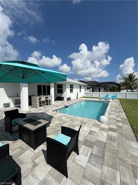 MODERN CAPE CORAL LIVING LESS THAN ONE MILE FROM THE 7 ISLANDS PROJECT! This stunning 2024 completed pool home brings together modern design, impressive finishes, and an exceptional location in one of Cape Coral's most exciting areas. Offering 4 bedrooms, 2 bathrooms, and 1,932 square feet of beautifully finished living space, the home is situated on a spacious fenced corner lot in a lovely established neighborhood. Less than one mile from the highly anticipated 7 Islands Project, you are ideally positioned near one of Cape Coral's most exciting waterfront development areas. CITY WATER AND SEWER ARE ALREADY IN PLACE, adding significant convenience and value. Inside, the home welcomes you with 24x24 porcelain tile throughout, 8 foot interior doors, all NEW interior paint, contemporary lighting, and a tray ceiling that adds volume and character to the main living area. The open concept kitchen is designed to impress with white wood cabinetry, a large quartz island, abundant storage, and stylish pendant lighting, creating a beautiful space for both everyday living and entertaining. The spacious primary suite features dual vanities, quartz countertops, custom cabinetry, a walk in shower, and a walk in closet with custom closet additions. Step outside to your private pool, with a NEW pool heater addition, and enjoy a spacious fenced yard with plenty of room to relax and entertain while you're hanging around the pool. This combination of newer construction, modern finishes, impact resistant windows and doors, metal roof, heated pool, city water and sewer, corner lot, and an exceptional location near the 7 Islands Project makes this a standout opportunity in Cape Coral. Come experience this home and see why the location, design, and lifestyle make this property truly special.