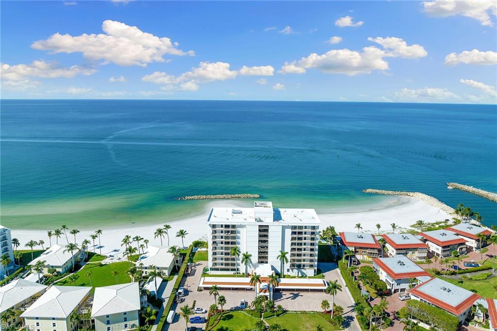 Experience the best of Naples beachfront living with breathtaking, unobstructed Gulf views from this beautifully reimagined two-bedroom, two-bath residence at Gulf View Beach Club. Perfectly positioned to embrace its spectacular waterfront setting, this light-filled coastal retreat opens to an expansive covered and screened balcony, where panoramic Gulf vistas, gentle sea breezes and unforgettable sunsets create the ultimate backdrop for relaxed seaside living. Completely renovated back to the studs in 2021, the residence has been thoughtfully transformed with a fresh, contemporary coastal aesthetic, showcasing sophisticated neutral finishes, clean architectural lines and an inviting open-concept design. The beautifully updated kitchen flows effortlessly into the living and dining areas, creating a seamless space for entertaining or simply enjoying the spectacular views. Additional features include a custom-built-in workspace, convenient in-residence laundry, a new air-conditioning system installed in 2025, assigned parking and dedicated storage. Nestled along an exceptionally picturesque, cove-like stretch of Gulf shoreline just south of Doctor's Pass, Gulf View Beach Club enjoys one of Naples' most captivating beachfront settings. The gently curving coastline creates an intimate, almost private beach atmosphere, with sweeping views across the turquoise waters of the Gulf. An exclusive boutique community of just 32 residences, the building offers a rare sense of privacy and tranquility, complemented by direct beach access, a Gulf-front swimming pool and sun deck, a fitness center, a social room, on-site management, private storage and convenient kayak and paddleboard racks. Just minutes from the world-class shopping, dining and entertainment of Fifth Avenue South, Third Street South and Waterside Shops, this exceptional residence combines the serenity of a secluded beachfront retreat with the convenience of Naples' finest destinations. A rare opportunity to enjoy a completely reimagined Gulf-front residence in an extraordinary coastal setting.