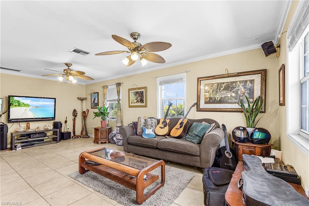 GREAT OPPORTUNITY to own a piece of picturesque Pine Island! This home sits on an oversized lot (.8 acres). The two adjacent vacant lots are for sale (MLS #2026002820 and #2026002921) and a package deal would give you more than 1.6 acres of PEACE and TRANQUILITY! This elevated ranch home provides 3 BR and 2 full baths. he primary bedroom has an ensuite bathroom. Bedrooms 2 and 3 share a (jack and jill) bathroom. The enclosed ground level space doubles the square footage providing flexibility and potential rental income. Multiple outbuildings are on site providing workshop, storage and creative space. The opportunities are endless! With some TLC, you can live your life in this serene and quiet environment.
The lower level is fully enclosed and includes a full apartment with a fully equipped kitchen, living room, bedroom and full bath bring the total living area to 2,112 sf. The lower level recently generated $1,200 in monthly rent. The home is in flood zone X, so flood insurance is not required.