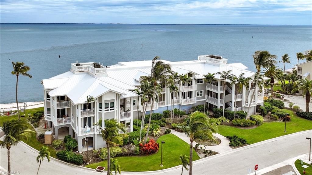 Experience waterfront luxury at its finest in this stunning three-bedroom, three-bathroom condominium nestled within the prestigious South Seas Resort, Captiva Island's most exclusive waterfront destination. This meticulously renovated 1,405-square-foothaven feels more like an elegant home than a traditional condo, thanks to the visionary design work by renowned designer Aniko and master contractor Will Smith, who elevated the space with top-of-the-line finishes throughout. Step inside to discover exquisite craftsmanship where panoramic views of Pine Island Sound create a backdrop that rivals the world's finest luxury yachts. The northeastern tip of the island location offers unparalleled privacy while providing spectacular colorful sunrise views over the Sound and breathtaking sunsets over the Gulf of Mexico. From your windows, witness dolphins and manatees playing directly in the pristine waters below—a wildlife lover's dream come true. The Seabreeze Villa's unique eight-unit design includes covered parking for both vehicles and golf carts, plus generous interior and exterior storage options. Choose to participate in the exclusive Club Captiva membership to unlock access to South Seas' world-class amenities (currently enrolled in Timbers most exclusive rental agreement 'Homes of Distinction'), seaside dining venues, Captiva Landing, Bayview pools, upcoming spa services, and the coveted opportunity to lease dock space at South Seas Yacht Harbour for vessels up to 100 feet on daily, monthly, or annual terms. This premium location overlooks The Clutch Golf Course, offering stunning fairway vistas, while the legendary Redfish Pass provides exceptional sportfishing opportunities just moments away. The property provides effortless access to the enchanting upper islands within minutes, positioning you at the heart of Southwest Florida's most sought-after boating and fishing paradise. Whether you're seeking a primary residence, vacation retreat, or lucrative investment opportunity through the established Homes of Distinction Rental Program, this property delivers exceptional returns on every front. The rare combination of resort-style luxury amenities, pristine natural surroundings, and sophisticated living spaces creates an unmatched island lifestyle where extraordinary moments unfold daily in your own private paradise.