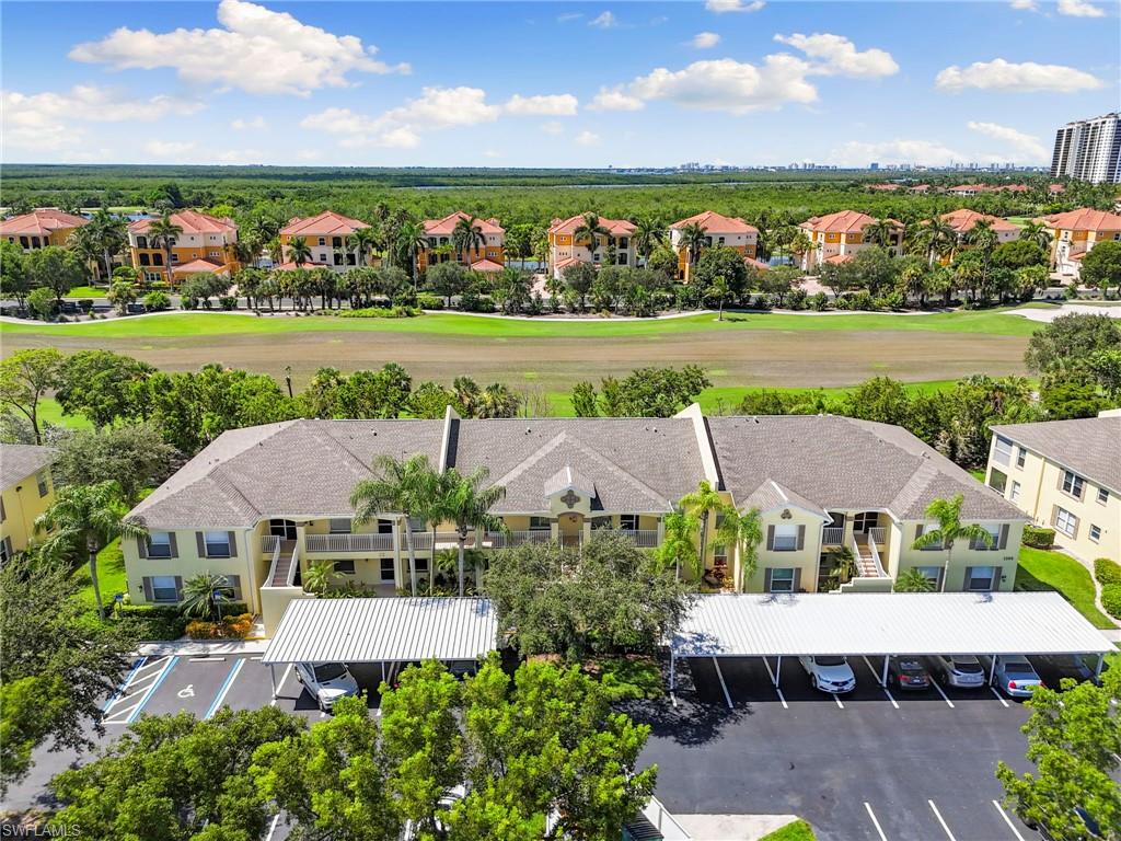 Embrace the relaxed Southwest Florida lifestyle at Fairways at Marco Shores, where peaceful golf course views, beautiful surroundings, and an ideal location between Naples and Marco Island make every day feel like a getaway. Imagine starting your mornings with coffee on your private screened lanai as you take in the lush green fairways of Hammock Bay Golf Course, spending sunny afternoons lounging by the community pool, and ending your evenings enjoying waterfront dining or spectacular Gulf Coast sunsets. This beautifully updated 2-bedroom, 2-bath condominium offers the perfect blend of comfort, style, and easy coastal living. Inside, an inviting open floor plan features stylish laminate flooring, abundant natural light, and a modern kitchen with sleek quartz countertops and crisp white cabinetry, creating a welcoming space for entertaining or simply relaxing after a day in the Florida sunshine. The spacious primary suite provides a peaceful retreat with generous closet space and a private bath, while the guest bedroom offers comfortable accommodations for family and friends. In-unit laundry and assigned covered parking add everyday convenience. Perfectly positioned between the charm of Marco Island and the vibrant lifestyle of Naples, you'll enjoy easy access to pristine beaches, championship golf courses, boating, fishing, shopping, and an incredible selection of restaurants. Whether you're looking for a winter escape or a year-round home, this inviting residence offers an opportunity to enjoy the sunshine, scenery, and laid-back coastal lifestyle that make Southwest Florida so special.