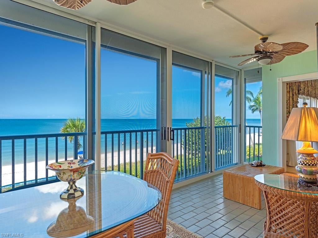 Experience beachfront living at The Laurentians along Naples’ coveted Miracle Mile, south of Doctors Pass, where white sand lies just steps away and gentle Gulf breezes accompany spectacular sunsets. This four-bedroom, four-bath residence offers 3,339 square feet of living space, with Gulf views extending across the kitchen, dining room, living room, and primary suite. Generous gathering areas provide ample room for entertaining, while spacious bedrooms and abundant closets accommodate everyday living and visiting guests. The primary suite includes a beachfront sitting area with northern and western exposure, complemented by a bath with dual sinks and a separate tub and shower. Electric hurricane shutters, an assigned under-building garage parking space, and a private storage room add convenience. With just 32 residences across two buildings and only two residences per floor, The Laurentians offers a sense of privacy within beautifully maintained beachfront grounds. Amenities include a community pool, bike storage, electric vehicle charging, on-site management, and secure building access. Nearby, the Four Seasons Resort Naples adds to the neighborhood’s appeal as a luxury destination, alongside the coastal setting of Lowdermilk Beach Park. The celebrated restaurants, boutiques, and galleries of Fifth Avenue South and Third Street South are just a short drive away.