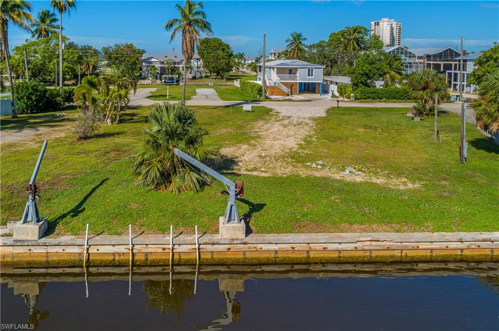 CITY OF BONITA SPRINGS BUILDING, WATER AND SEWER IMPACT FEES ARE ALREADY PAID ON THIS CANALFRONT, SEAWALLED, GULF-ACCESS WATERFRONT VACANT LOT!!! Represents BIG SAVINGS for the Buyer!
BONUS: NO HOA. HO HOA FEES! Just One Bridge (at New Pass) to QUICKLY be in THE GULF WATERS! Your Southwest Florida Waterfront building opportunity is here, and the Heavy-Lifting is Already DONE! With the City of Bonita Springs Building, Water and Sewer Impact Fees Already PAID, You start Your project with Real Savings and a Faster path from purchase to permit. Add NO HOA and NO HOA FEES, and You have a rare, Highly desirable combination. This Canal-Front Lot is already Sea-Walled, so You can focus on design instead of site work. Boaters and Anglers will Love the location! From the canal, it’s a Short-Run to the Gulf of America with just one bridge at New Pass along the way. Build up to 35 feet with West facing exposure, and You may enjoy partial Bay Views and Sunsets from the upper levels. Please take a look at the aerial photo. This lot sits in an established neighborhood laced with calm canals with mangrove-lined Bay waters just beyond. You can see the HYATT REGENCY COCONUT POINT RESORT, PELICAN LANDING & RITZ-CARLTON RESIDENCES at Estero Bay in the distance. The drive there is approximately 10 minutes. Luxury Landmarks close by, while You come Home to a laidback neighborhood. Nature is Your neighbor. The BAY Waters and mangroves nearby are a Favorite for fishing, kayaking, paddle boarding, boating and Sunset cruises. Wildlife such as dolphins, manatees and wading birds are part of life on the Southwest Florida coast. For builders and investors, the numbers speak for themselves: PAID City Impact Fees, a Sea-Walled Canal Lot (cleared), quick Gulf-Access, NO HOA, NO HOA FEES, all in a Upscale, desirable area. It’s a strong foundation for a custom coastal Home at a good value. Please Call for more information.