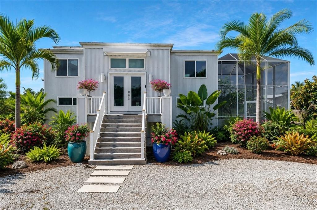 See Zillow link for 3D walkthrough - Situated on 2.27 private acres in Golden Gate Estates, this unique nearly 2,900 sq ft residence offers exceptional flexibility, privacy, and modern living with room to grow, work, and thrive. The upper level, completed in 2022, features 2 bedrooms, 2 full baths, open living area, and updated kitchen with newer appliances. The newly CO’d ground level, completed in 2026, adds another living room, 2 bedrooms, 1.5 baths (With bidet "smart" toilet), and direct backyard access—ideal for multi-generational living, guests, or future rental potential with room for a kitchenette. Built with galvanized steel construction and impact-rated doors/windows throughout for enhanced durability and long-term performance. Considered superior construction, the home offers favorable insurability, and the seller has already secured flood insurance. A 24x40 detached steel workshop with three garage doors (One 10-ft tall and two doors are 12 ft. tall) provides outstanding space for business owners, storage, hobbies, or recreational vehicles. A large screened outdoor enclosure offers exceptional flexibility for future lanai expansion, tropical gardening, entertaining, or potential pool integration. The grounds feature an impressive variety of fruit trees, vegetables, and herbs for sustainable living. Whole-house reverse osmosis system and tankless water heater included. Seller will also include riding lawn mower. Sunshades/screens for water treatment area, carport, and central circular area to be installed soon. Please make sure to see the video of this beautiful property as well.