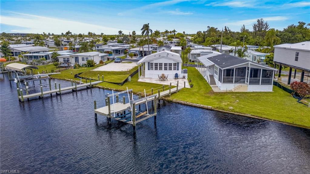 Direct Gulf Access newer home with private dock. This beautifully maintained 2021 Jacobsen home, one of the newest in Orange Harbor, offers modern construction rated for winds up to 140 MPH for exceptional durability and peace of mind. Wake up to peaceful riverfront views and the true Southwest Florida boating lifestyle in this beautifully maintained waterfront home located in the gated, resident-owned Orange Harbor 55+ community. Situated along the scenic Orange River with direct access to the Caloosahatchee River and Gulf of America, this property offers a rare opportunity to enjoy private boating access at an exceptional value.

Designed for both relaxation and entertaining, the home features inviting front and rear outdoor living spaces enhanced with newly finished decorative concrete patios. The spacious rear patio overlooks the river and lush tropical surroundings where manatees, dolphins, birds, and other native wildlife are often seen passing by.

Boating enthusiasts will appreciate the private dock, two fish lights, a 10,000 lb boat lift, and GEM remote lift system for convenient operation and easy days on the water. The furnished interior includes 2 bedrooms, 2 bathrooms, a bright kitchen with island, new refrigerator, comfortable living spaces, and a large enclosed front lanai ideal for entertaining, relaxing, golf cart parking, or additional storage.

Orange Harbor is a professionally managed, pet-friendly waterfront community offering outstanding amenities including two private boat ramps, on-site boat storage, fish cleaning stations, resort-style pool, clubhouse, pickleball, bocce ball, dog park, social activities, and more. Conveniently located near I-75, downtown Fort Myers, restaurants, shopping, and entertainment.

Enjoy affordable waterfront Gulf-access living with your own private dock and lift in one of Fort Myers’ most active boating communities.