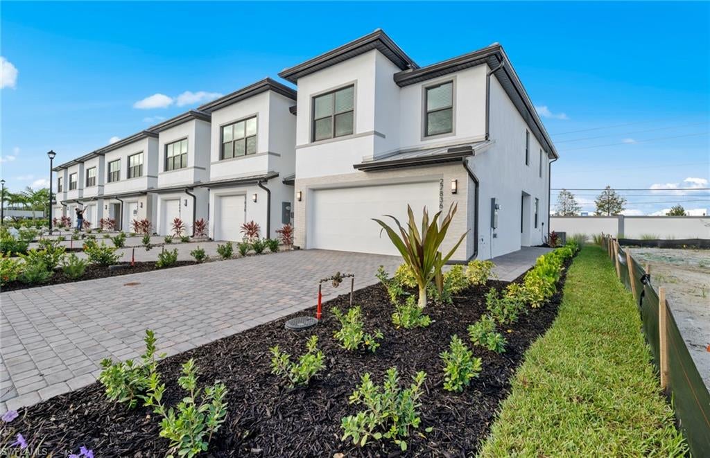 Solis Grande Townhomes 3 bed 2.5 baths with 2 car garage screened lanai Quartz Counters throughout large kitchen island,, full Whirlpool appliance package, including washer dryer.
