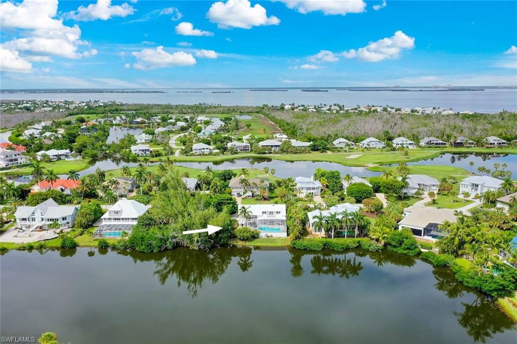For the buyer who appreciates exceptional design and meticulous attention to detail, this exquisitely redesigned home in Sanibel’s Dunes neighborhood is a pleasure to experience. Offering three bedrooms, three-and-a-half baths, and approximately 2,350 square feet under air, it pairs beautifully finished interiors with lake views and an elevated saltwater pool. Wonderful for entertaining, the main living spaces flow toward the screened pool deck for a seamless indoor-outdoor lifestyle. Gather around the custom beverage bar, with its dedicated wine refrigerator and refrigerated drawers, or enjoy the outdoor kitchen, complete with a grill, refrigerator, and backlit Crystallo stone counter. The heated pool makes it easy to enjoy the setting year-round. In the kitchen, custom cabinetry, natural stone, a Buechel stone backsplash, and an ILVE induction range with dual ovens and a warming drawer reflect the care invested in every finish. Custom feature walls enrich the living and dining areas, while wood stairs and handrails, thoughtfully selected lighting, and custom closet systems carry the design throughout the home. The primary suite offers a beautifully appointed bath with honed marble walls and floors, plus custom thermal blackout window treatments. Every bath features a frameless glass enclosure.
Practical details have received the same attention: a whole-home dehumidifier, HVAC germicidal UV light, filtered and softened water, a tankless water heater, James Hardie exterior siding, and impact windows and doors. The sliders are protected by hurricane shutters. Walk to the bayfront beach, bike to Gulf beaches, and enjoy Sanibel’s paths, shelling, shops, library, and nature trails. Golf, tennis, and pickleball amenities in the Dunes are available with an annual membership. Select furnishings and other items are included.