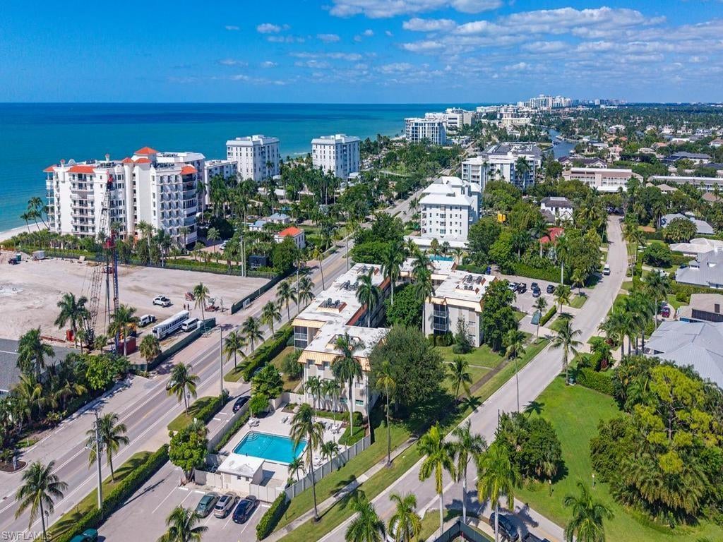 If you are looking for the perfect Naples get-a-way, look no further! This beautifully remodeled 2 bedroom /2 bathroom condo is situated across the street from spectacular Naples Beaches keeping you in walking distance of the Gulf! Modern high gloss cabinetry, custom mirrors, updated lighting, quartz counter tops and wood flooring are a few of the high end finishes that make this unit a standout!  The primary bathroom and guest bathroom have been completely renovated with mosaic shimmering glass tile and top of the line fixtures. The community pool is heated for year round swimming or relaxing. Impact windows and sliders make your unit storm ready. The 1100 Club is located minutes from the numerous cultural activities that Naples has to offer along with fine dining and shopping in Venetian Village or downtown Naples! Don't let this one get away!