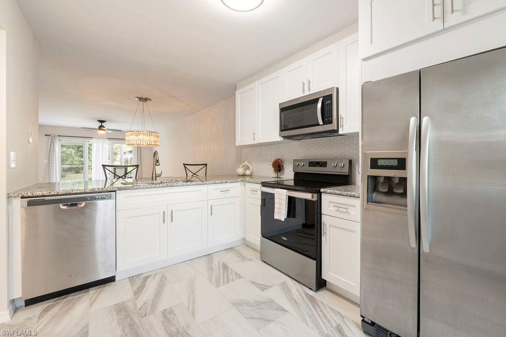 Beautifully remodeled 2-bedroom 2-bathroom condo on THE GROUND FLOOR. Very quiet boutique community with one of the lowest HOA fees in Naples. Brand new kitchen cabinets and granite countertops. Stainless steel appliances. The entire unit boasts stylish new tile flooring and fresh paint throughout including doors and baseboards. No "popcorn" on the ceiling- the ceiling is newly done and painted. New water heater and newer a/c unit. Impact windows and sliding glass doors for extra security. Large master suite with walk in closet. Experience the convenience of a separate, spacious laundry room complete with a washer and dryer and room for storage. Relax in your screened-in lanai, which overlooks a tranquil, private area—perfect for morning coffee or evening relaxation. Reserved parking spot and plenty of guest parking.