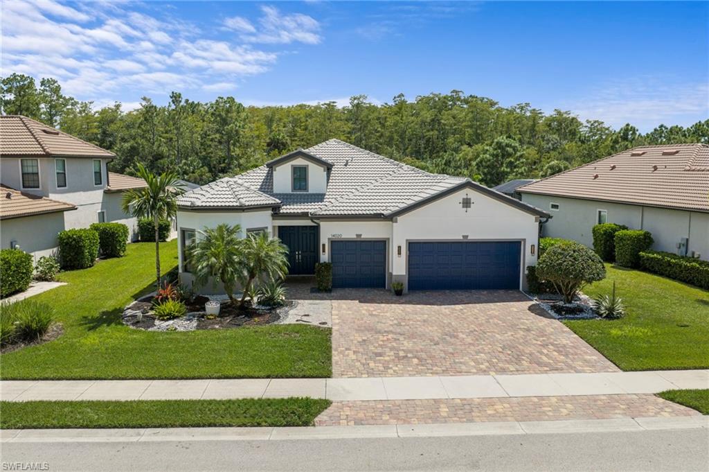 One or more photo(s) has been virtually staged, AI generated or rendered.  STUNNING STONEWATER FLOOR PLAN in the highly desirable Corkscrew Shores community! This spacious 3-bedroom + den, 3-bath home with a 3-car garage offers over 2,800 square feet of beautifully designed living space. Featuring tile flooring throughout, soaring ceilings, and an open-concept floor plan perfect for entertaining. The gorgeous kitchen overlooks the expansive great room and features an oversized island, white wood cabinetry, cooktop, and stainless steel appliances. Custom built-in entertainment wall and elegant tray ceiling add character to the main living area. The spacious primary suite features an oversized shower, dual sinks, and a large walk-in closet with custom organization. Enjoy outdoor entertaining on the oversized screened lanai with built-in bar and propane grill! The 3-car garage features a freshly epoxied floor. Corkscrew Shores is a spectacular gated community surrounded by natural preserves and centered around a breathtaking 240-acre lake where electric, wind-powered, and manually powered boats are permitted. Resort-style amenities include a pool and spa, fitness center, movement studio, massage room, tennis, pickleball, basketball, bocce, playground, fishing pier, and scenic walking trails. Golf carts are permitted for licensed drivers, making it easy to cruise to the popular Captain's Club restaurant and sports bar for waterfront dining! Experience the ultimate Florida lifestyle in one of Estero's most sought-after communities! One or more photo(s) has been virtually staged, AI generated or rendered.