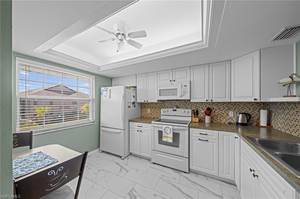 Welcome to this beautifully renovated second-floor condo in the desirable 55+ Foxmoor community, where comfort, convenience, and easy Southwest Florida living come together. This immaculate 2-bedroom, 2-bath home is move-in ready, being sold turnkey, and offers an ideal low-maintenance lifestyle for seasonal or full-time residents.

Thoughtfully updated throughout, the condo features new tile and wood-look laminate flooring, fresh interior paint, modern lighting, and a new A/C and furnace installed in 2023 with a transferable 10-year warranty. The building also received a new roof in 2024. Best of all, the unit has never experienced flooding.

The bright eat-in kitchen has been completely refreshed with brand-new cabinetry, white appliances, a stylish contemporary backsplash, and a convenient pass-through to the spacious living and dining area. The open layout creates a comfortable, inviting space for entertaining or relaxing at home.

The generously sized primary suite offers a walk-in closet and a beautifully updated private en-suite bathroom. Both bathrooms have been tastefully remodeled with modern tile, updated fixtures, and contemporary finishes.

Step outside to the screened-in lanai and enjoy your morning coffee or evening beverage while overlooking the beautifully landscaped community grounds. An exterior storage closet with a washer and dryer adds even more convenience.

Foxmoor residents enjoy a wonderful selection of amenities, including a community pool, gazebo, BBQ and picnic area, and shuffleboard courts. The HOA fee is $550 per month and includes flood insurance, making this an especially convenient and low-maintenance place to call home.

Located close to shopping, dining, grocery stores, entertainment, I-75, area airports, and Downtown Fort Myers, this beautifully updated condo offers the opportunity to enjoy all that Southwest Florida has to offer in a welcoming 55+ community.