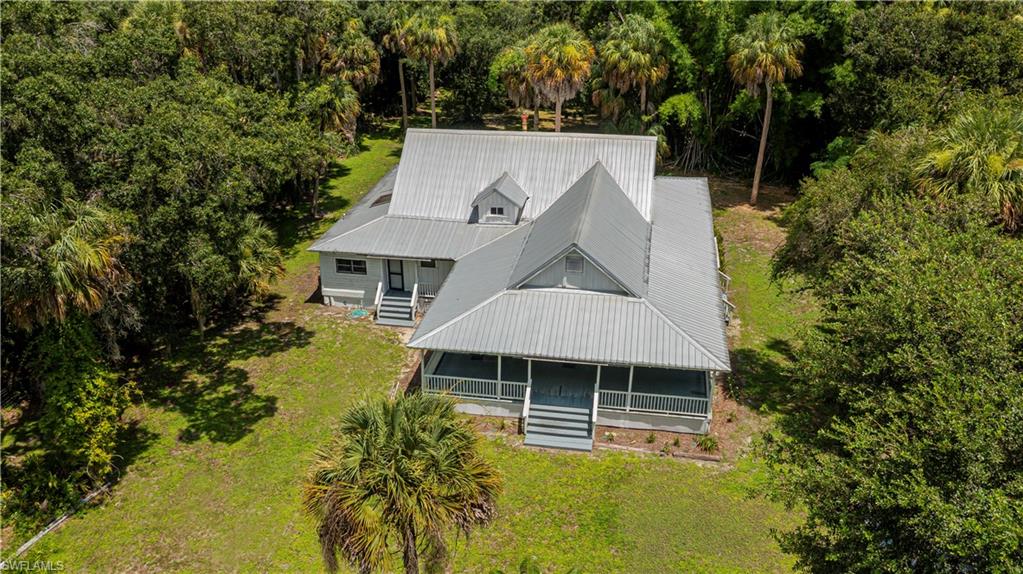 A ONCE-IN-A-GENERATION OPPORTUNITY to own one of LaBelle’s most historically significant properties! The Caldwell Home Place offers a remarkable connection to the earliest days of LaBelle, with a history dating to at least 1897 and possibly earlier. Originally serving as a trading post and general store along the Caloosahatchee River, the building also served as LaBelle’s early post office before becoming the Caldwell family’s treasured Home Place in 1907. Today, this extraordinary Florida vernacular home remains a tangible piece of Old Florida history and is listed on the National Register of Historic Places.

Situated on approximately 2.195 acres and comprised of THREE SEPARATE PARCELS, the property offers a combination rarely found with a historic home: the Home Place, an UNFINISHED GUEST HOUSE, and TWO ADDITIONAL BUILDABLE LOTS. The unfinished guest house provides an opportunity for a future owner to complete and customize an additional living space, while the separate buildable parcels create even greater flexibility. Preserve the property as a private residence, establish a unique family compound, or explore the possibilities offered by the additional parcels and improvements.

The home itself tells a story that simply cannot be recreated. Its raised construction, expansive porches and steep roof reflect early Florida architecture, while generations of history remain embedded throughout the property. Perhaps most remarkable is the famous porch wall where family members and visitors have recorded their names and heights since the 1920s—hundreds of handwritten marks documenting generations of life at the Home Place.

Properties can be renovated. Houses can be built. But history like this cannot be reproduced. The Caldwell Home Place represents an exceptionally rare opportunity to become the next steward of an irreplaceable piece of LaBelle history while acquiring 2.195 acres across three parcels, an unfinished guest house, and two additional buildable lots.