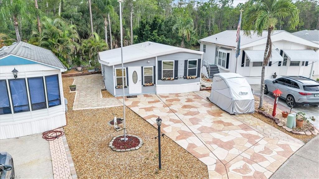 Virtually Staged. Welcome to Corkscrew Woodlands! This furnished 1-bedroom, 1-bath single-wide manufactured home offers the perfect blend of comfort, convenience, and easy Florida living. Attractive curb appeal welcomes you with a spacious stamped concrete driveway, charming flower boxes, low-maintenance landscaping, a welcoming front entry, and a paver patio that creates the perfect outdoor space for relaxing, entertaining, or enjoying Florida's sunshine. Inside, you'll find a bright and inviting eat-in kitchen featuring abundant cabinetry, generous countertop space, and a functional U-shaped layout. Appliances include a refrigerator, range, and built-in microwave. Vaulted ceilings, decorative lighting, multiple windows, and wood-look flooring create a warm, open atmosphere that's perfect for everyday living and entertaining. One of the home's standout features is the spacious living room addition, providing valuable extra living space and flexibility. Complete with a Murphy bed, this area is ideal for hosting overnight guests while still serving as a comfortable everyday living room. A finished utility room with a washer and dryer provides added convenience and valuable storage space. As an added bonus, the golf cart is included with the sale, making it easy to explore and enjoy all that the community has to offer. Located within the highly desirable 55+ gated community of Corkscrew Woodlands, residents enjoy more than 123 acres of beautifully maintained grounds featuring scenic lakes, canals, walking, biking, and golf cart paths, plus a tranquil butterfly garden. Community amenities include tennis, pickleball, bocce ball, shuffleboard, a heated pool and spa, mini golf, a clubhouse, and an active social calendar with endless opportunities for recreation and relaxation. Please note that this is not a pet-friendly lot. Additional storage for RVs, vehicles, and more is available for a nominal fee. The low HOA fee includes water, cable TV, trash collection, and lawn care, leaving only electric to be paid separately. Best of all, you own the land! Whether you're looking for a seasonal retreat or a year-round residence, this move-in-ready home offers an affordable opportunity to enjoy the perfect balance of active living and peaceful natural surroundings. Start enjoying the Florida lifestyle from day one!" **PLEASE ENJOY THE 3D INTERACTIVE VIRTUAL TOUR ASSOCIATED WITH THIS LISTING**
